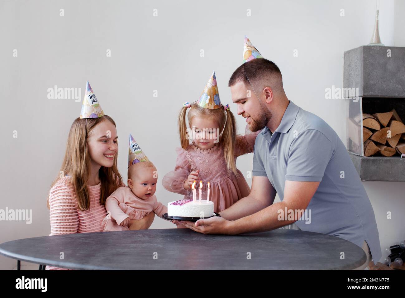 Happy family celebrating child birthday. Mother, father and two baby ...