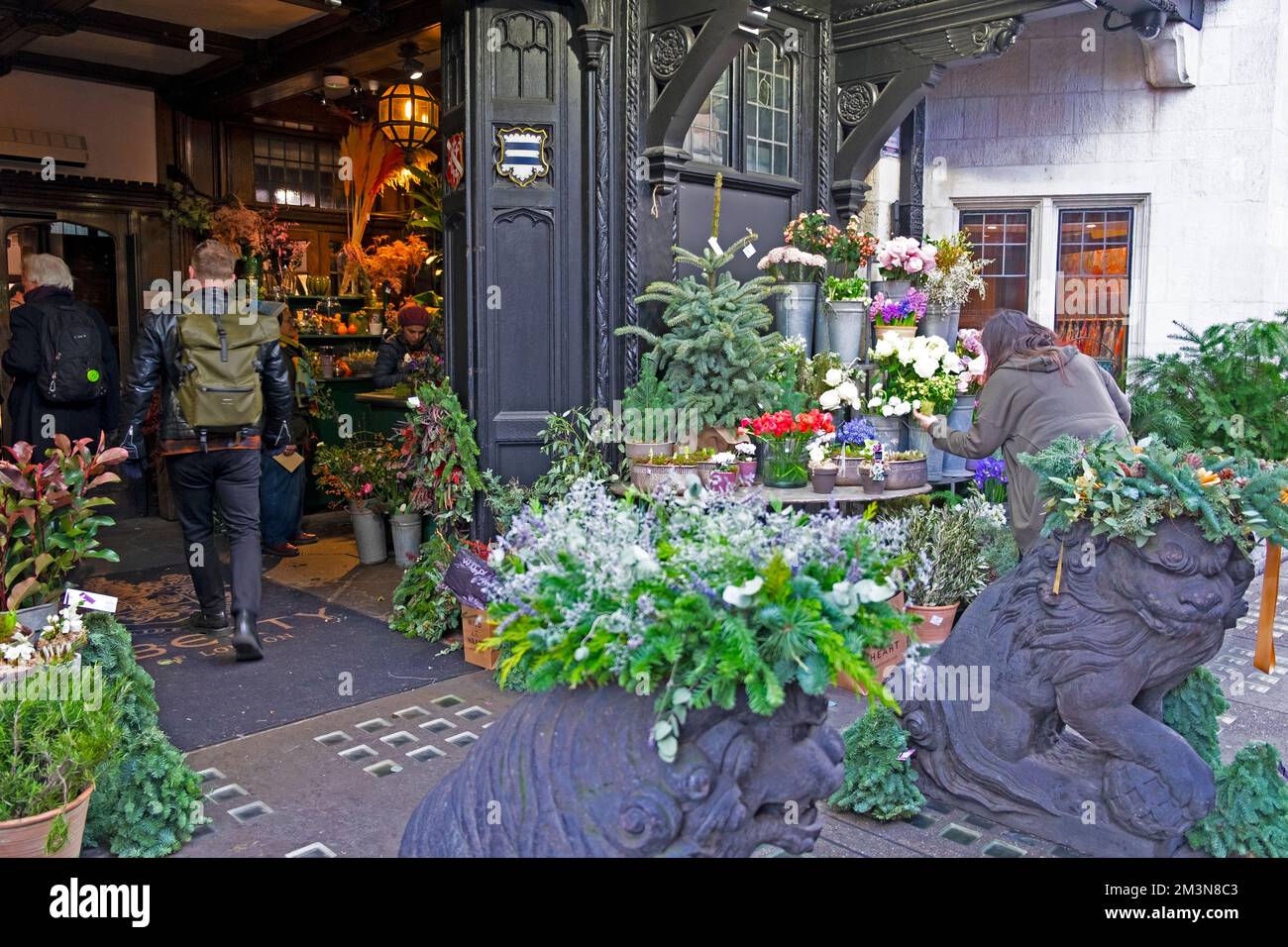 Florist selling cut flowers and branches at Christmas Xmas outside the