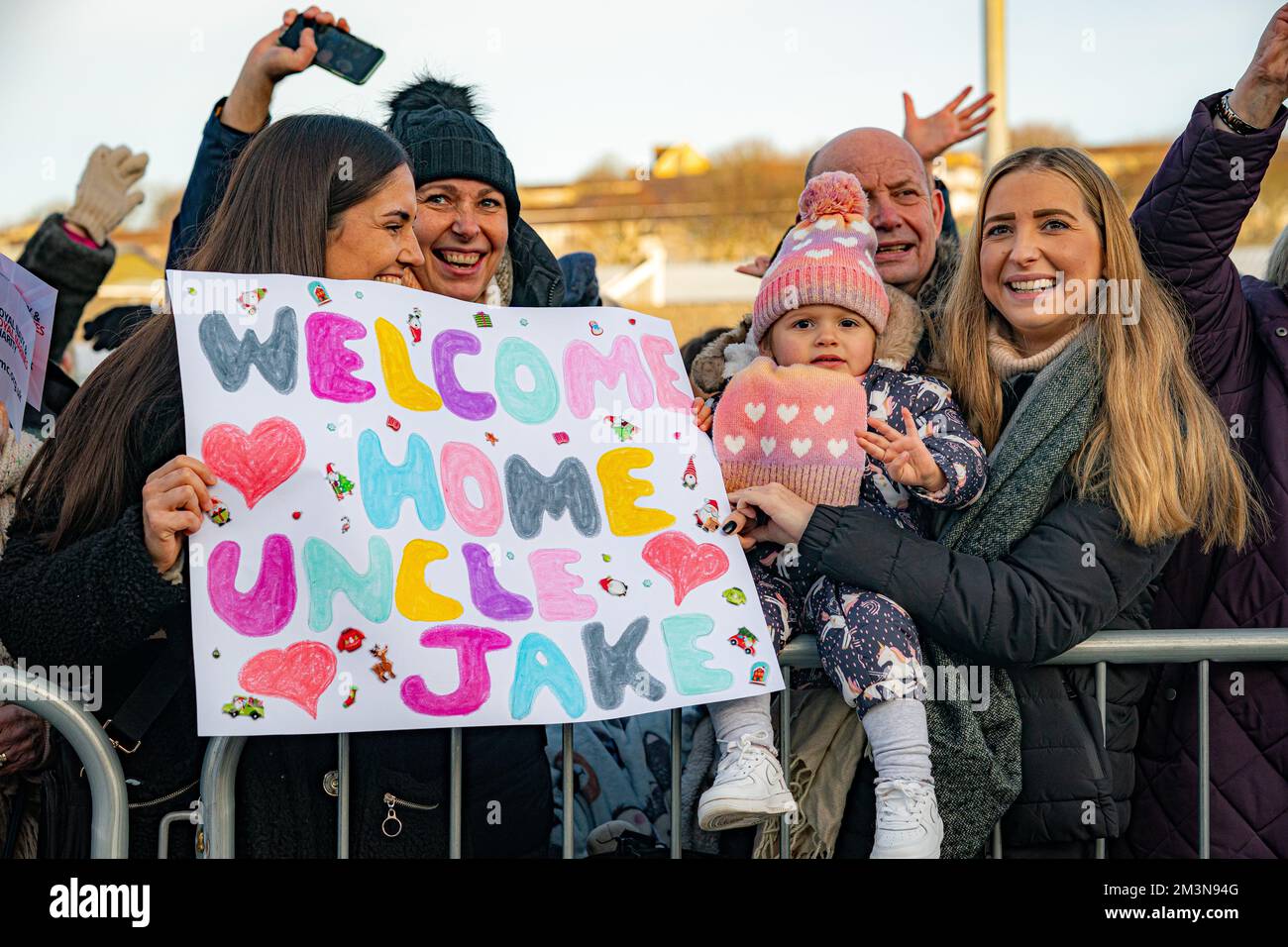People Hold Banners As Families And Loved Ones Greet The Return Of Hms
