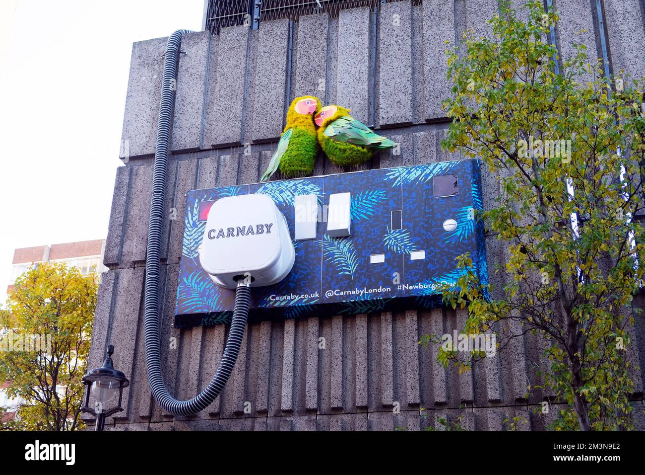 Christmas Carnaby giant wall plug and socket street art with two birds