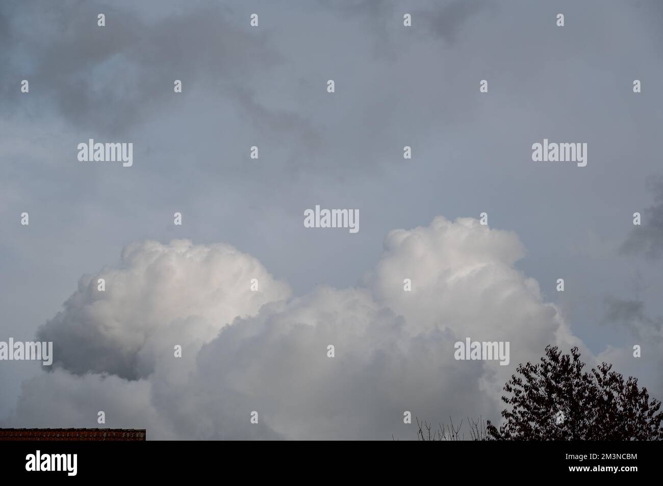 Large dark clouds move on a house roof and trees Stock Photo - Alamy
