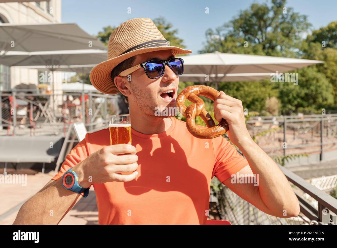 Tipsy girl with a glass of beer and a traditional German snack pretzel