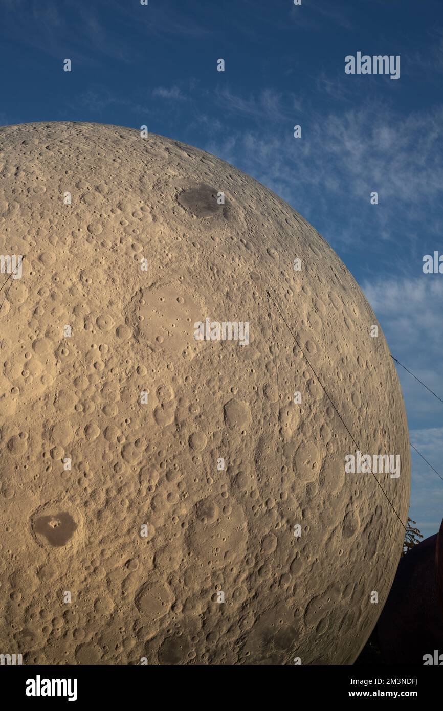 Large Moon Model A vertical closeup of a giant model of the Moon against a blue sky in ...