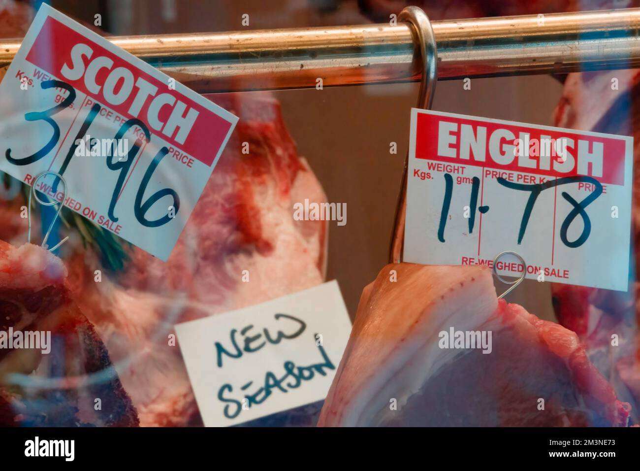 Window display of a British butcher showing various types of meat and their prices, London, UK Stock Photo