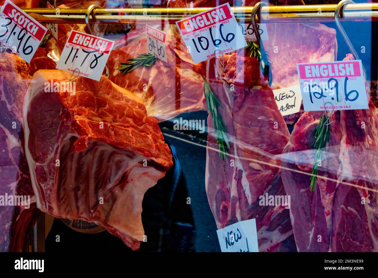 Window display of a British butcher showing various types of meat and their prices, London, UK Stock Photo