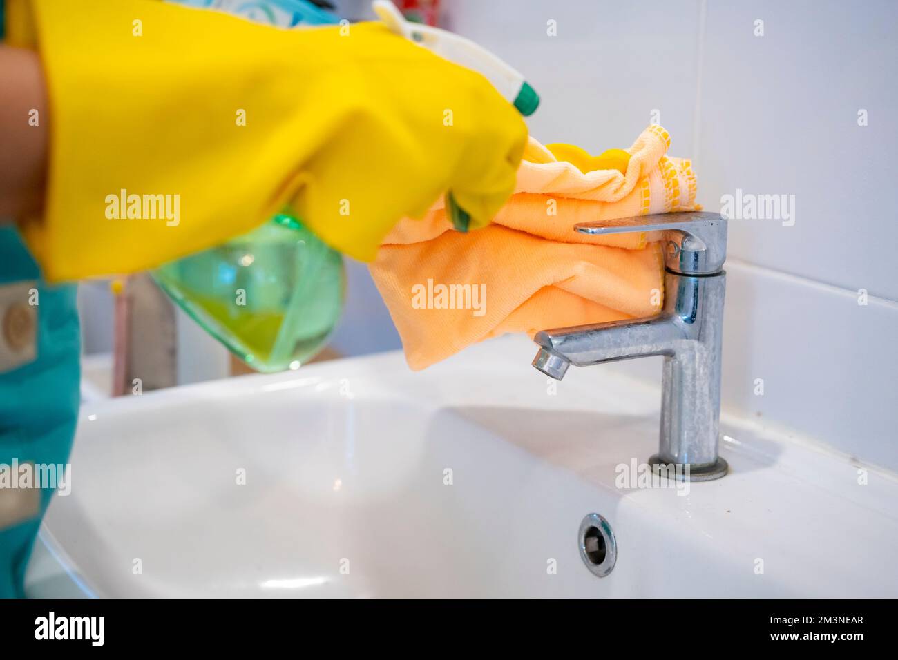 Part of woman clean hydrant at home. Image of young girl housekeeper