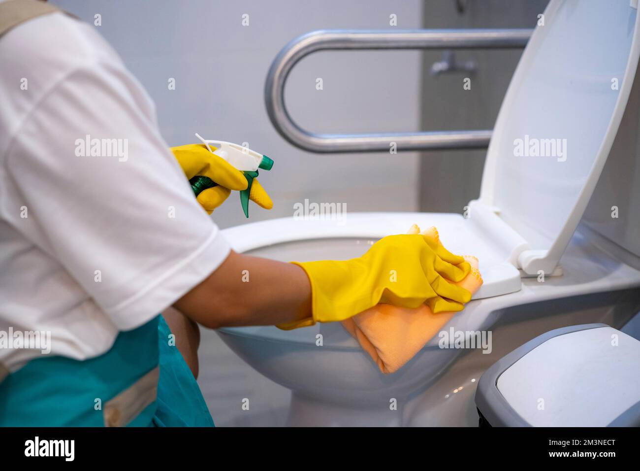 woman cleaning flush toilet at home. Image of young girl housekeeper cleaner, housekeeping