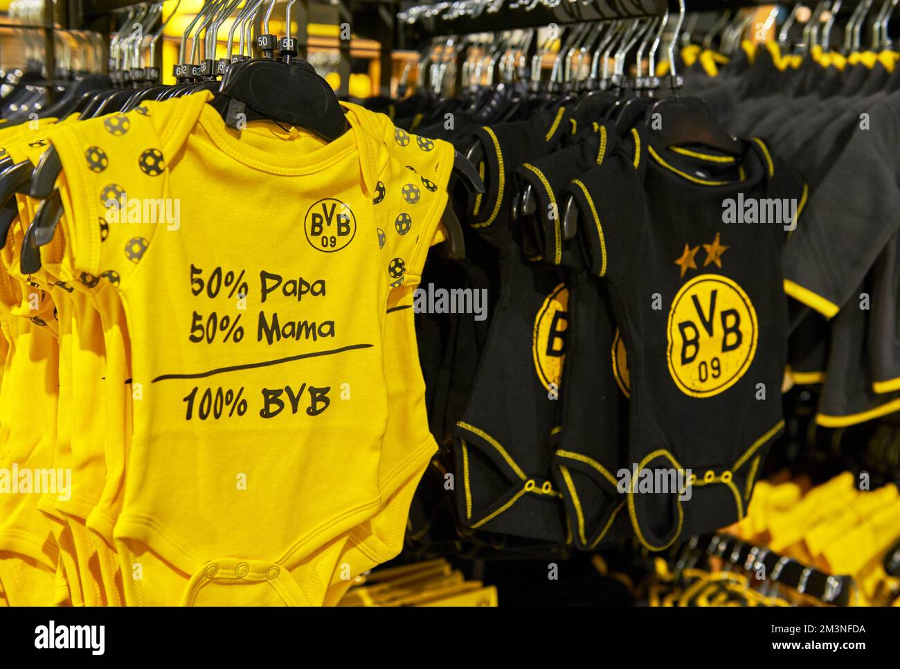 Cute baby overall on sale in FC Borussia Dortmund fan shop Stock Photo