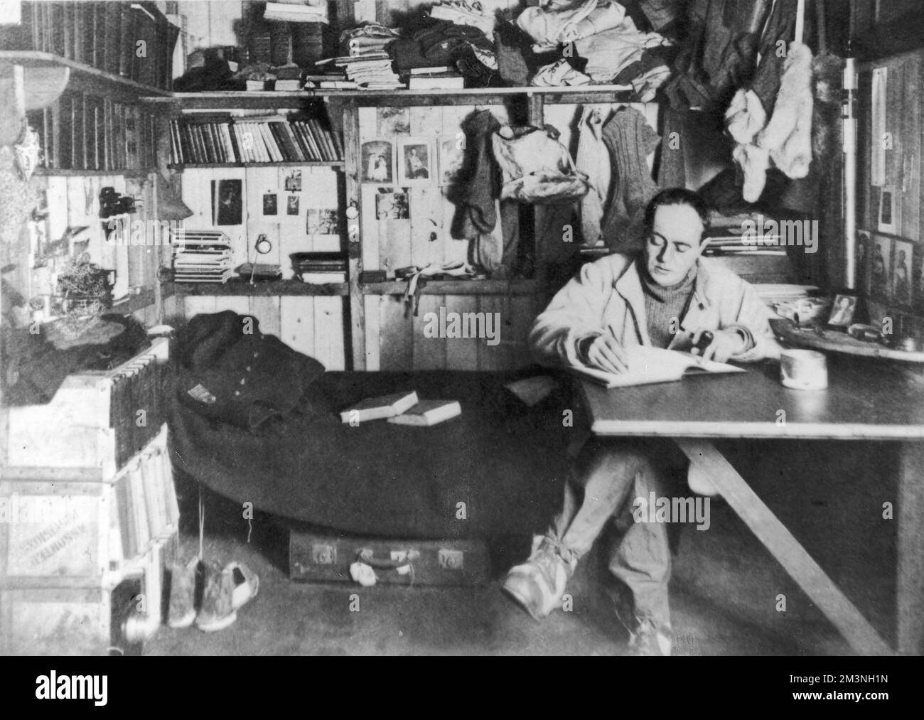 Captain Robert Falcon Scott (1868 - 1912), British polar explorer and leader of the ill-fated expedition to the South Pole in 1912, pictured in his work room on board the Terra Nova.     Date: 1911 Stock Photo