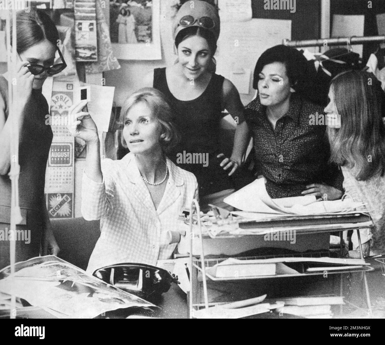 Evan Marie Saint (born 1924), American actress best known for starring in 'On the Waterfront' and 'North by North-West' pictured visiting the fashion department of the London Life magazine offices to pick up pointers for her role as a fashion editor in the film 'Grand Prix'.  With in this picture (left to right) are fashion writers, Sarah Drummond, Norma Moriceau, Gill Evans and Margaret Dreyfus.     Date: 1966 Stock Photo