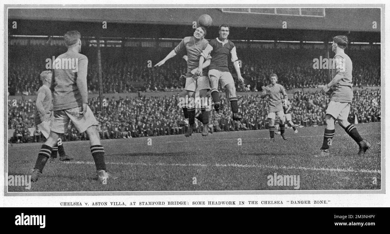 A footballer takes a header during the Chelsea v. Aston Villa match at Stamford Bridge, London.       Date: 1923 Stock Photo