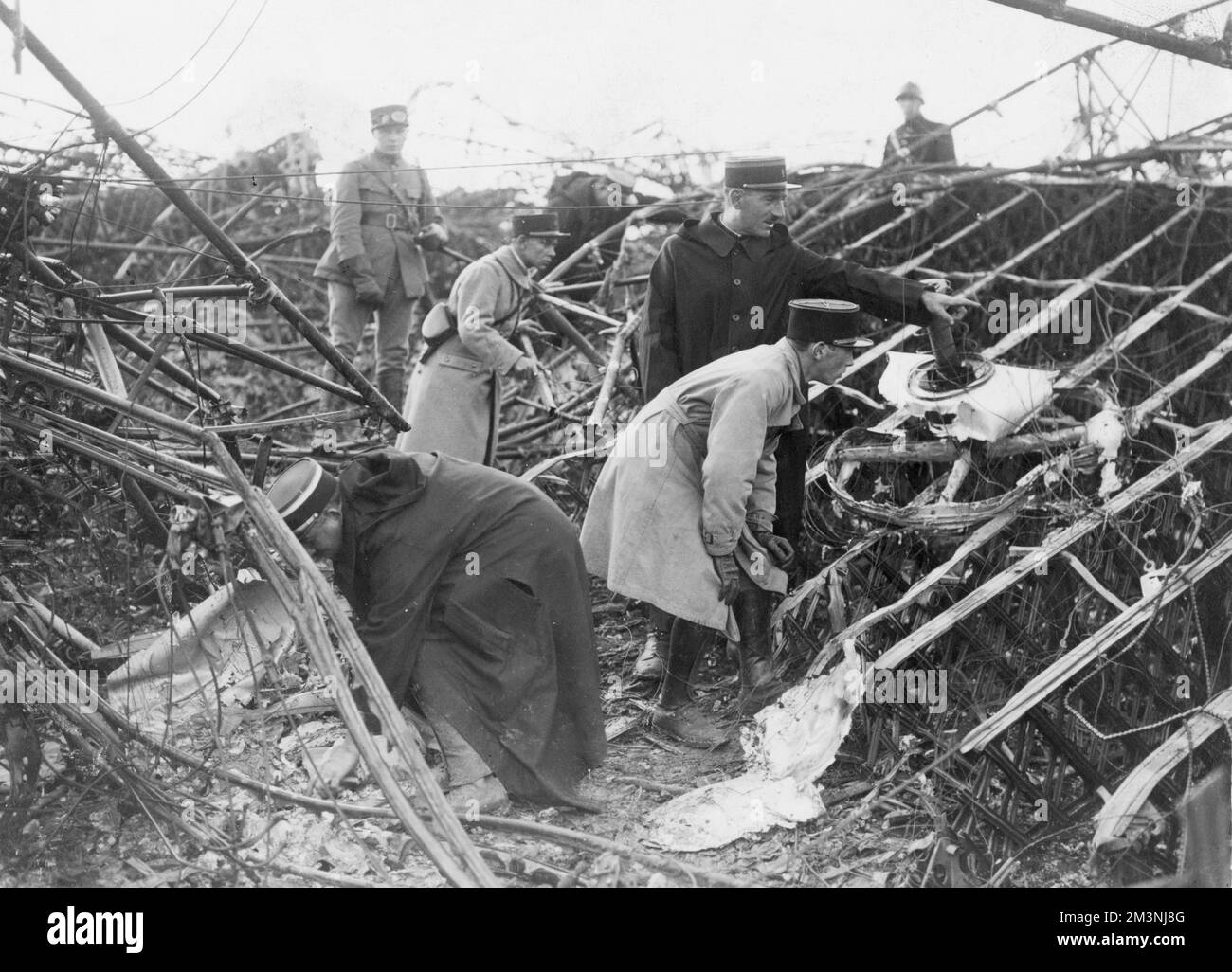 French police search through the wreckage of the British R101 airship that crashed near Beauvais in France on its maiden voyage to Egypt and India on 5th October 1930, with the eventual loss of 48 out of the 54 passengers, officials, officers and crew on board.     Date: October 1930 Stock Photo
