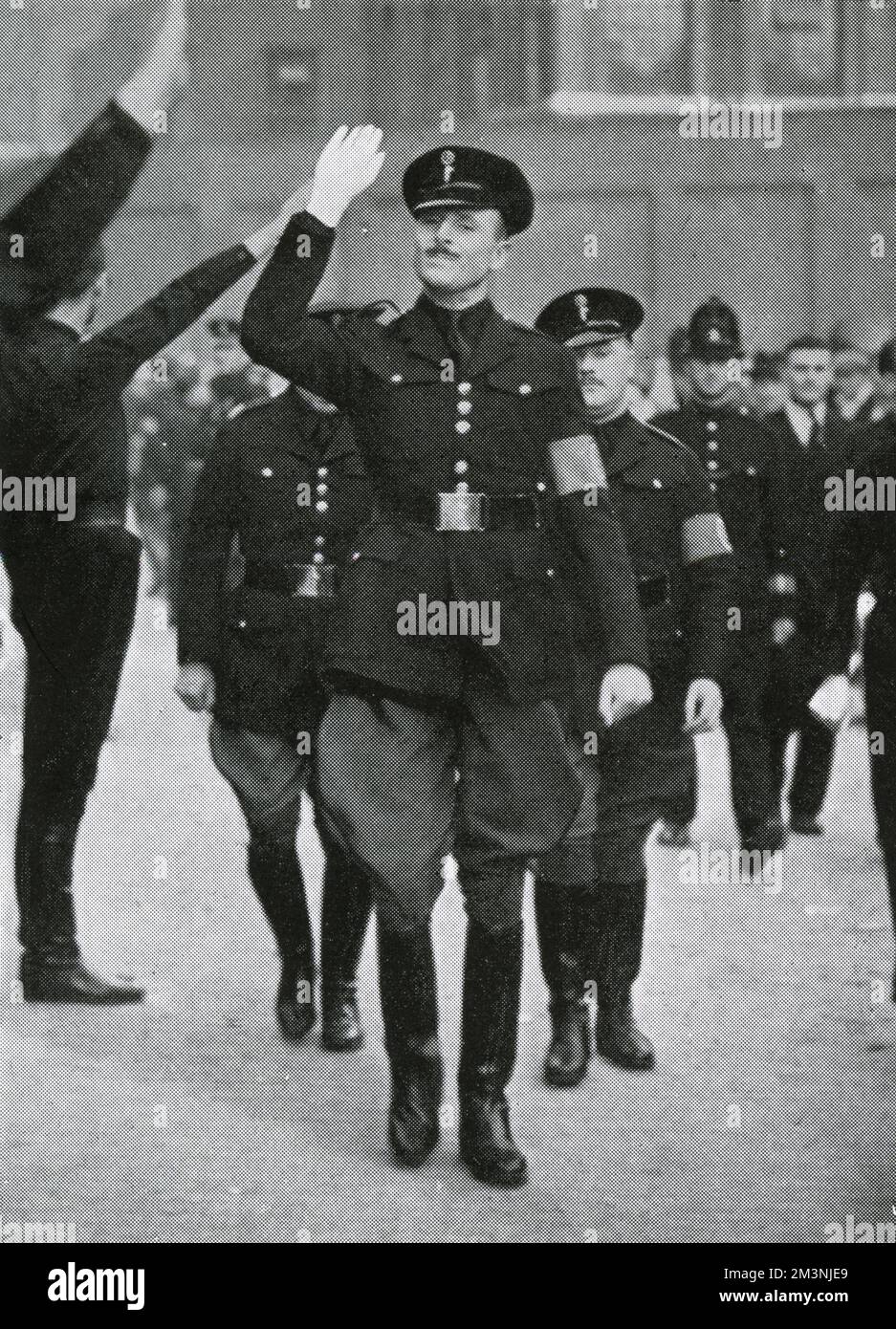 Sir Oswald Mosley arrives to review his Blackshirts, the British Union of Fascists, assembled in Royal Mint Street, before their proposed march through the East End of London. The march was diverted to avoid the enormous anti-fascist demonstration that had gathered to protest.     Date: 4 October 1936 Stock Photo