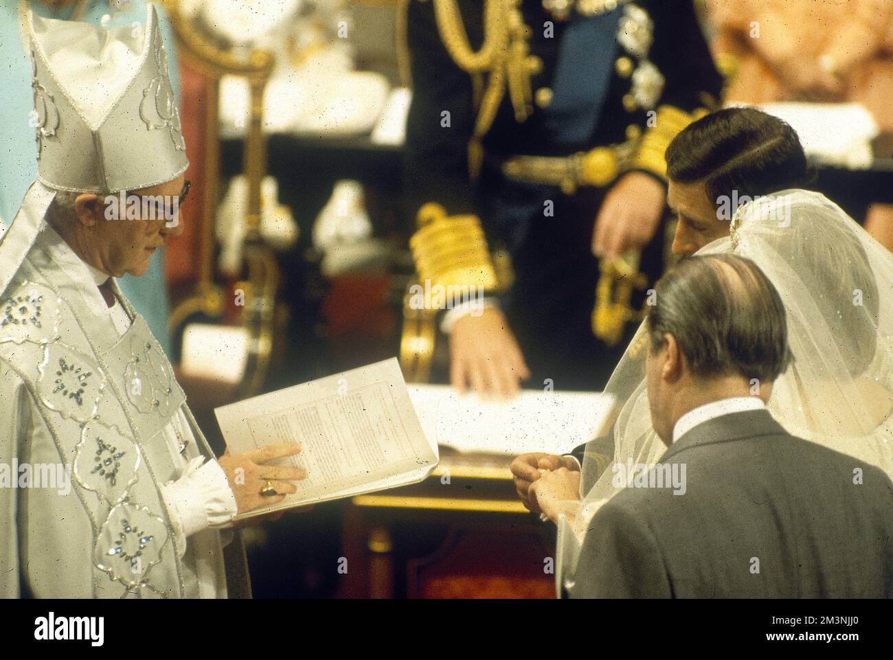 Marriage of Prince Charles to Lady Diana Spencer in St Paul's Cathedral on 29 July 1981.  The couple exchange rings under the watchful eye of the bride's father, Earl Spencer.  The ceremony was conducted by the Archbishop of Canterbury, Robert Runcie.     Date: 1981 Stock Photo