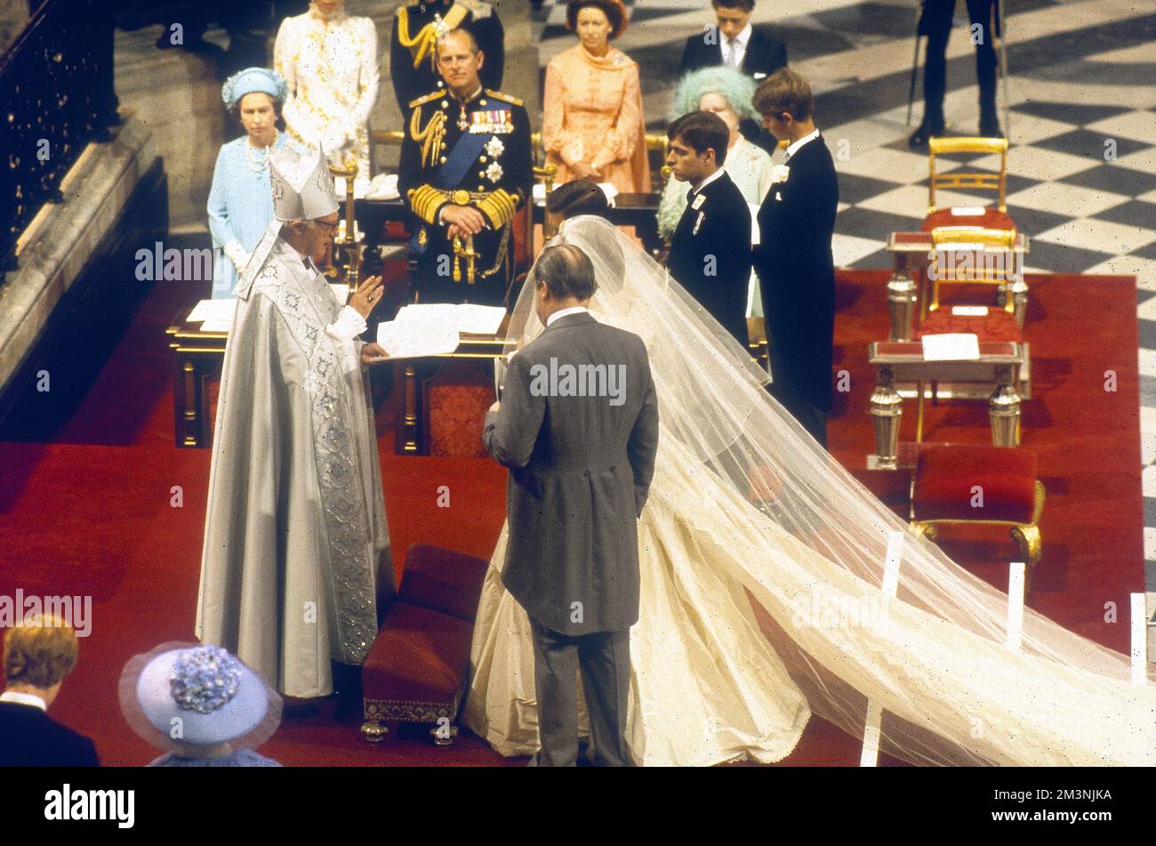 Prince Charles (Prince of Wales) and Lady Diana Spencer are married by the Archbishop of Canterbury, Robert Runcie in St Paul's Cathedral on 29 July 1981 in front of the Queen and other prominent members of the royal family.  The bride's father, Earl Spencer stands by ready to give his daughter away.     Date: 1981 Stock Photo