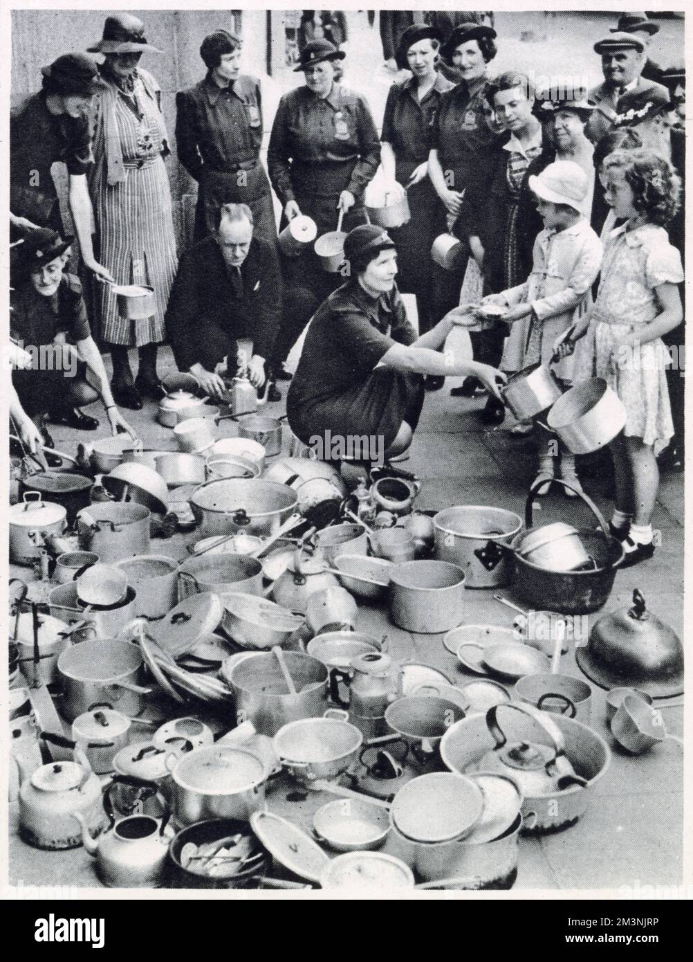 Lord Beaverbrook the Minister for Aircraft Production appealed for objects wholly or partly made of aluminium for the manufacture of aeroplanes. Photograph showing Lady Lucas Tooth who was in charge of a collecting centre of the Women's Voluntary Service in Chelsea receiving pots and pans from the public. Stock Photo