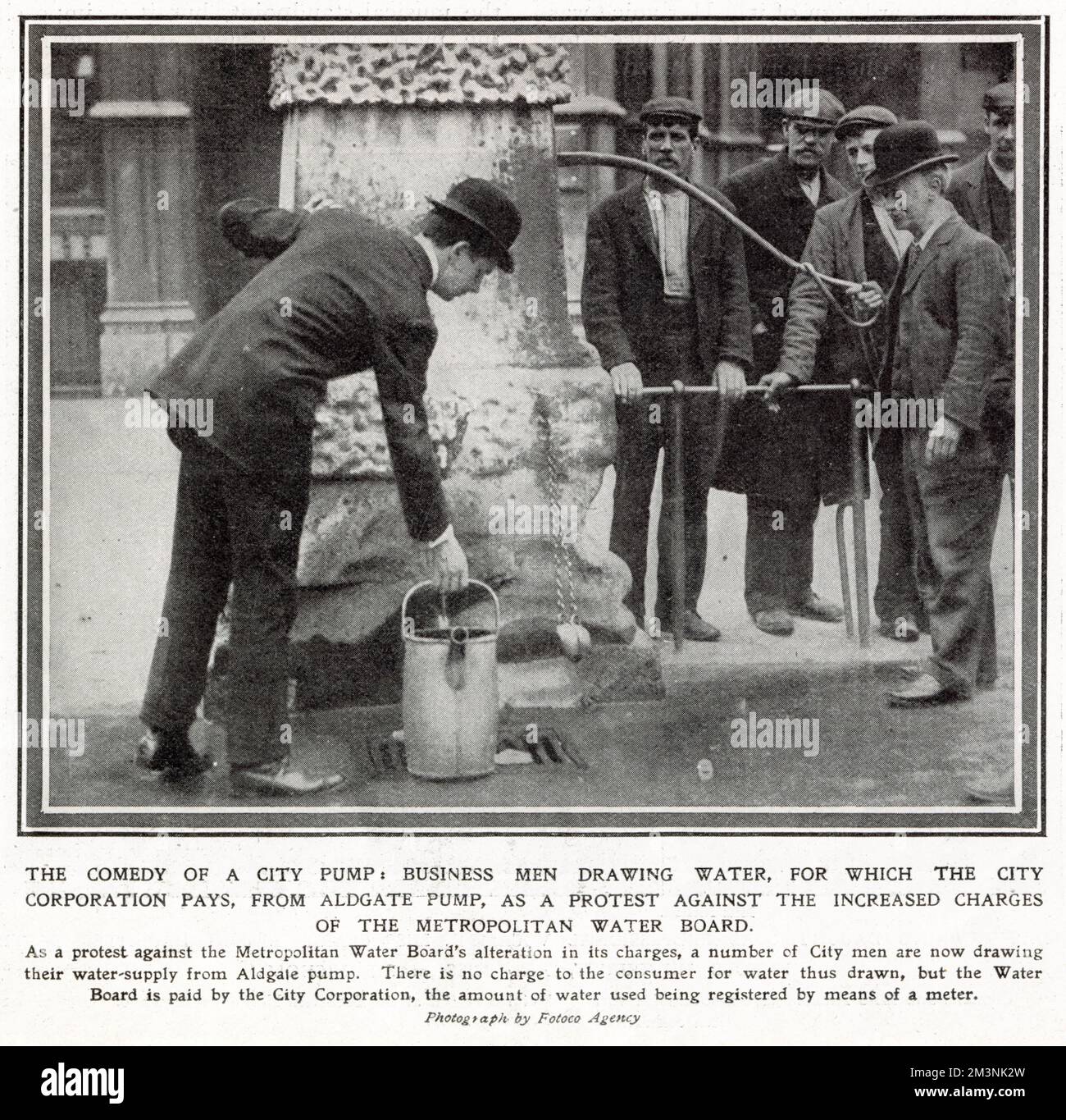 Local businesses were on protest against the increase charges of the Metropolitan Water Board on their registered meter. Photograph showing London City workers drawing water from the free Aldgate Pump to save money.      Date: 1908 Stock Photo