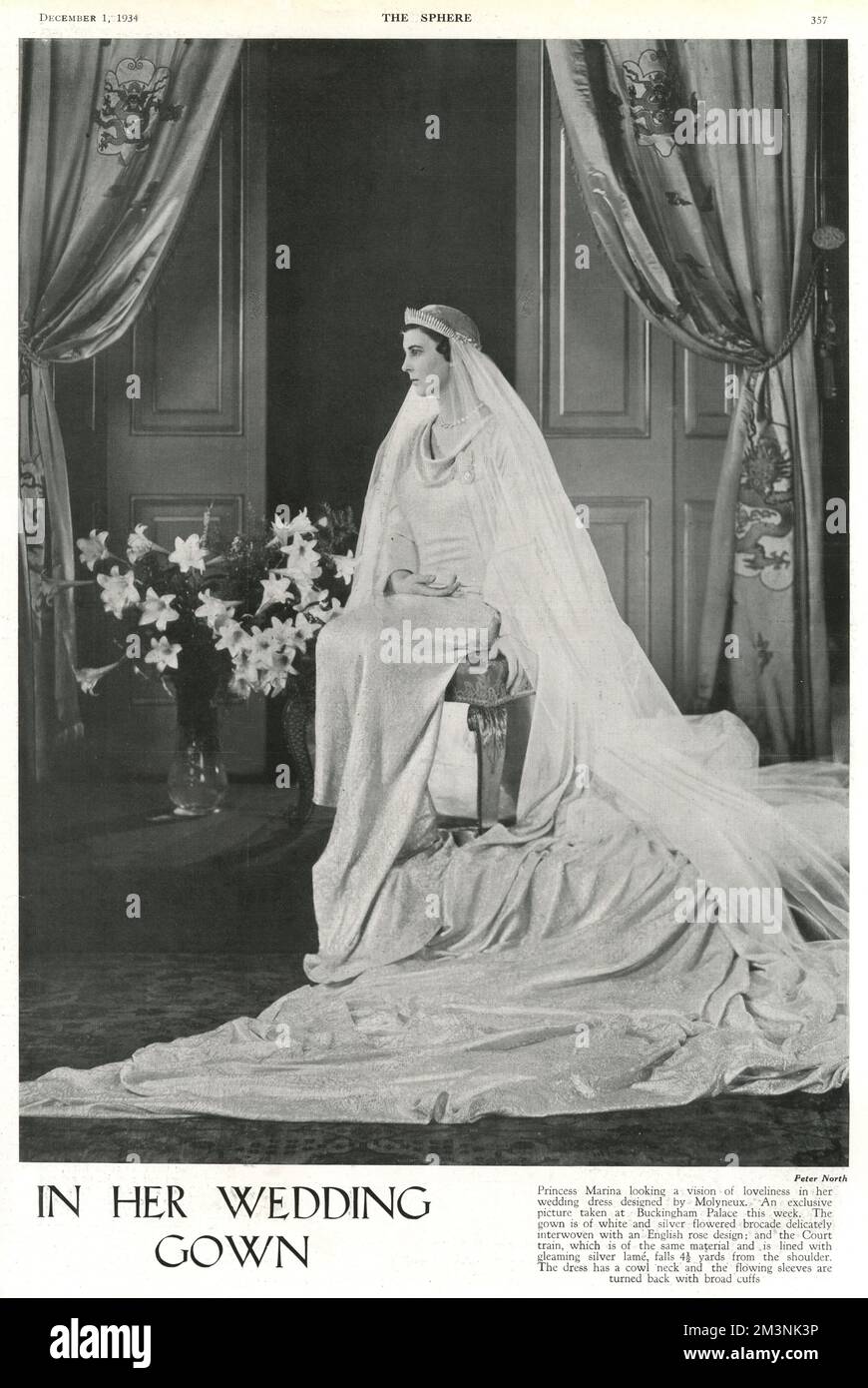 Princess Marina of Greece looking a vision of loveliness in her wedding dress designed by Captain Edward Molyneux in a photograph taken at Buckingham Palace the week before her wedding to Prince George, Duke of Kent at Westminster Abbey on 29 November 1934.  The gown was of white and silver flowered brocade delicately interwoven with an English rose design; and the Court train, of the same material and lined with silver lame, fell 4 and a 1/2 yards from the shoulder.  The dress had a cowl neck and flowing sleeves turned back with broad cuffs.     Date: 1934 Stock Photo