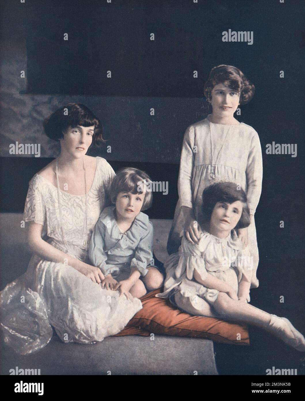 One of the eight bridesmaids at the royal wedding between Prince Albert, Duke of York and Lady Elizabeth Bowes-Lyon at Westminster Abbey on 26 April 1923, the Hon. Cecilia Bowes-Lyon, niece of the bride pictured with her mother, Lady Glamis (daughter of the tenth Duke of Leeds) and her twin brother and sister the Timothy and Nancy.     Date: 1923 Stock Photo