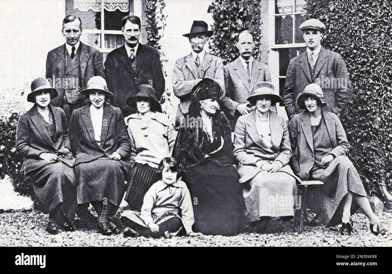 An informal group taken at Glamis Castle, the home of Lady Elizabeth Bowes-Lyon, the future Duchess of York and Queen Elizabeth, the Queen Mother.  From left seated, Lady Elizabeth Bowes-Lyon, Miss Betty Cator, Miss Betty Malcolm, Lady Strathmore, Lady Elphinstone, Lady Glamis.  Standing from left: Lord Elphinstone, Lord Glamis, Lord Strathmore, Captain Malcolm, The Hon. James Stuart and seated in front, Cecilia Bowes-Lyon, elder daughter of Lord and Lady Glamis.     Date: 1923 Stock Photo