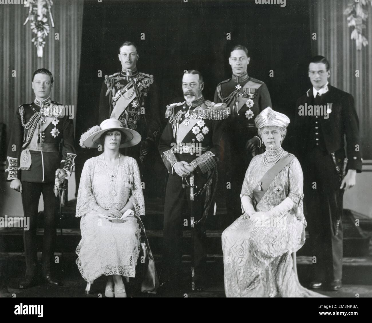 The British Royal Family on the wedding day of the Duke of York (later King George VI). From left to right: Prince Edward, Prince of Wales (later King Edward VIII, then Duke of Windsor after abdication); Princess Mary (Viscountess Lascelles, later Princess Royal, and Countess of Harewood); Henry, Duke of Gloucester; King George V; Albert, Duke of York (later King George VI); Queen Mary; George, Duke of Kent.     Date: 1923 Stock Photo