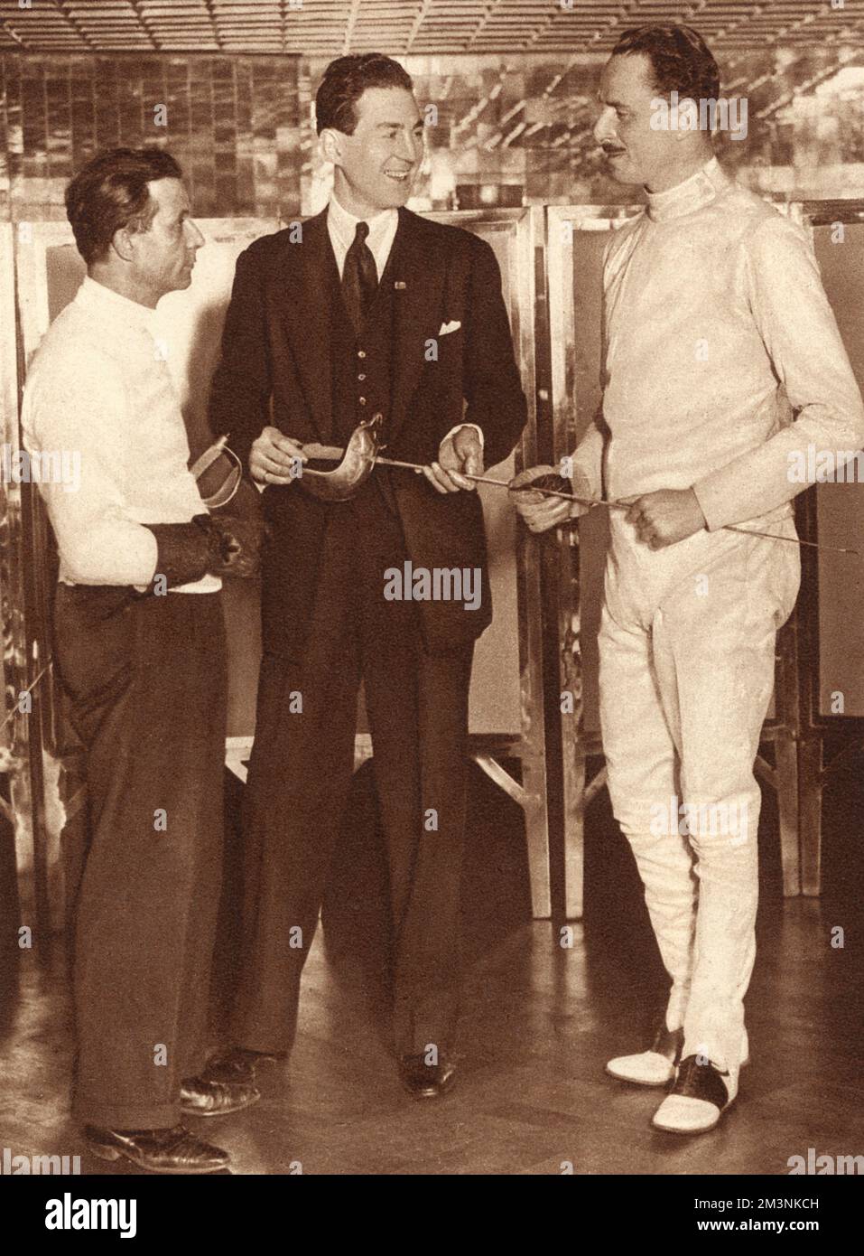 The Hon. David Tennant (1902-1968) and Sir Oswald Mosley (1896-1980) in their fencing attire at the Gargoyle Club, Dean Street, London,      Date: 1932 Stock Photo