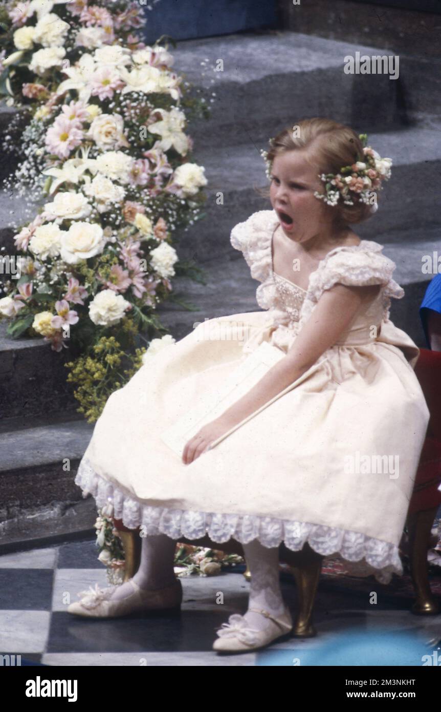 Charming picture, showing one of the bridesmaids at the wedding of Prince Andrew, Duke of York to Sarah Ferguson looking a little bored with events at Westminster Abbey on 23 July 1986.    1986 Stock Photo