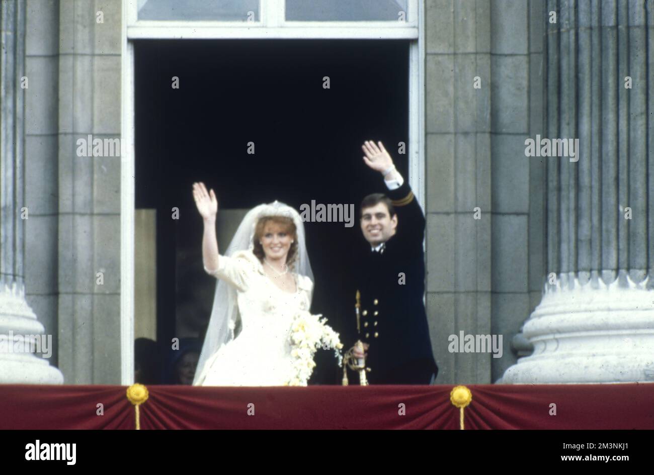 A newly married Prince Andrew, Duke of York and Sarah Ferguson, Duchess of York, wave at crowds as they leave the balcony of Buckingham Palace on their wedding day, 23 July 1986.  1986 Stock Photo