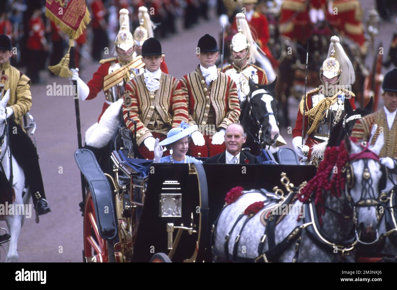 Queen Elizabeth II travels with Major Ronald Ferguson in an open top landau carriage through the crowd lined streets of London following the marriage of her son, Prince Andrew, Duke of York to Sarah Ferguson at Westminster Abbey on 23 July 1986.  1986 Stock Photo