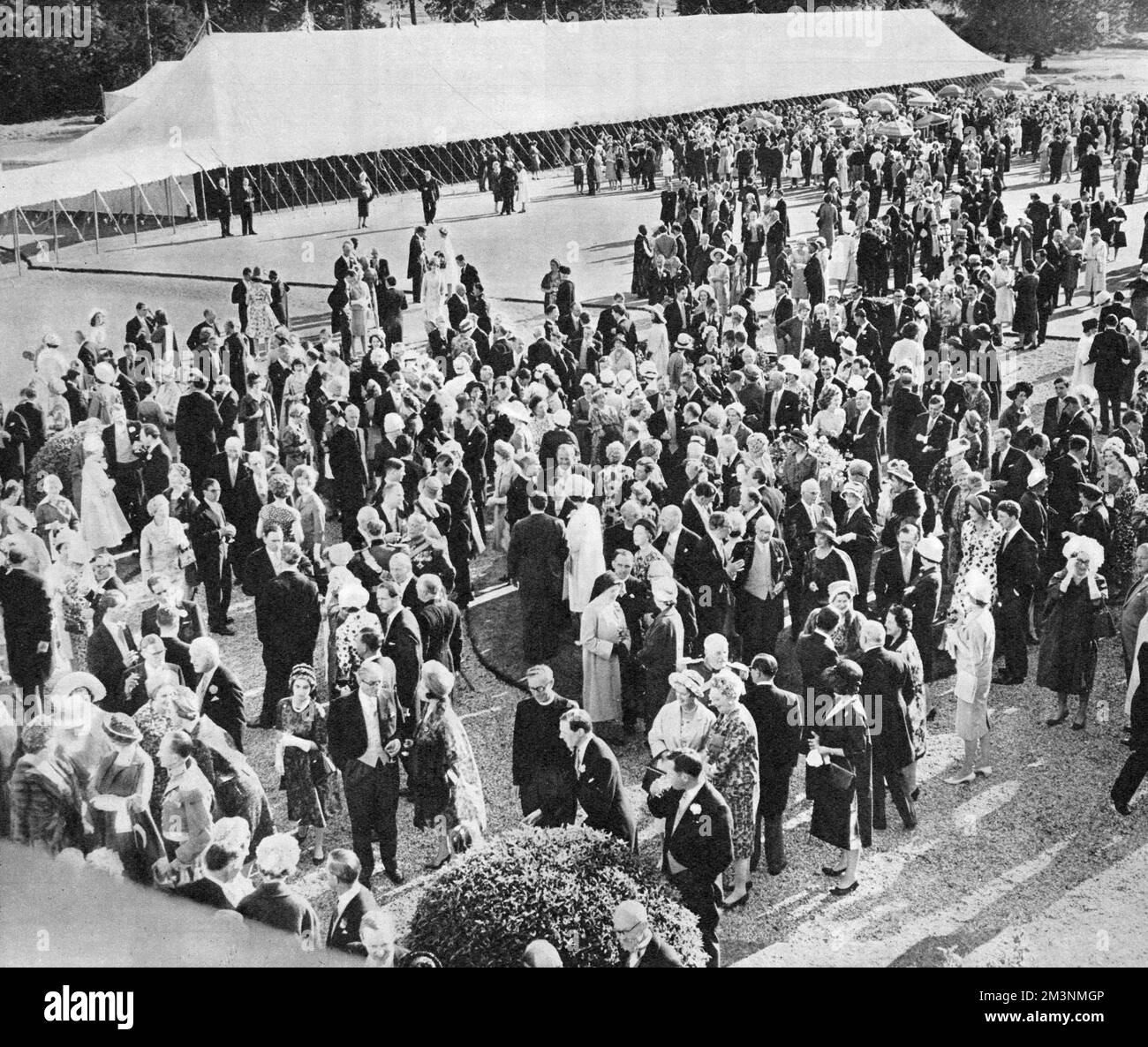 Some of the 2000 guests at teh wedding reception following the marriage of the Duke of Kent to Miss Katherine Worsley at York Minster on 8 June 1961.  The reception was held at Hovingham Hall, the bride's family home, and guests can be seen strolling about on the extensive lawns beside a vast marquee.     Date: 1961 Stock Photo