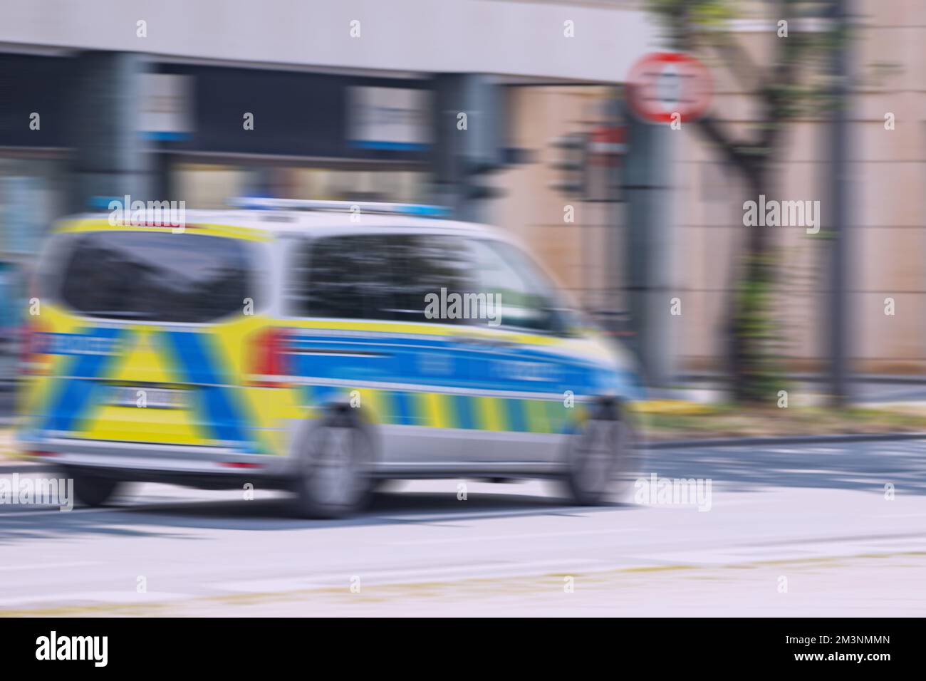Motion Blur of a German polizei or police car van is rushing on city street. Accident and speed concept Stock Photo