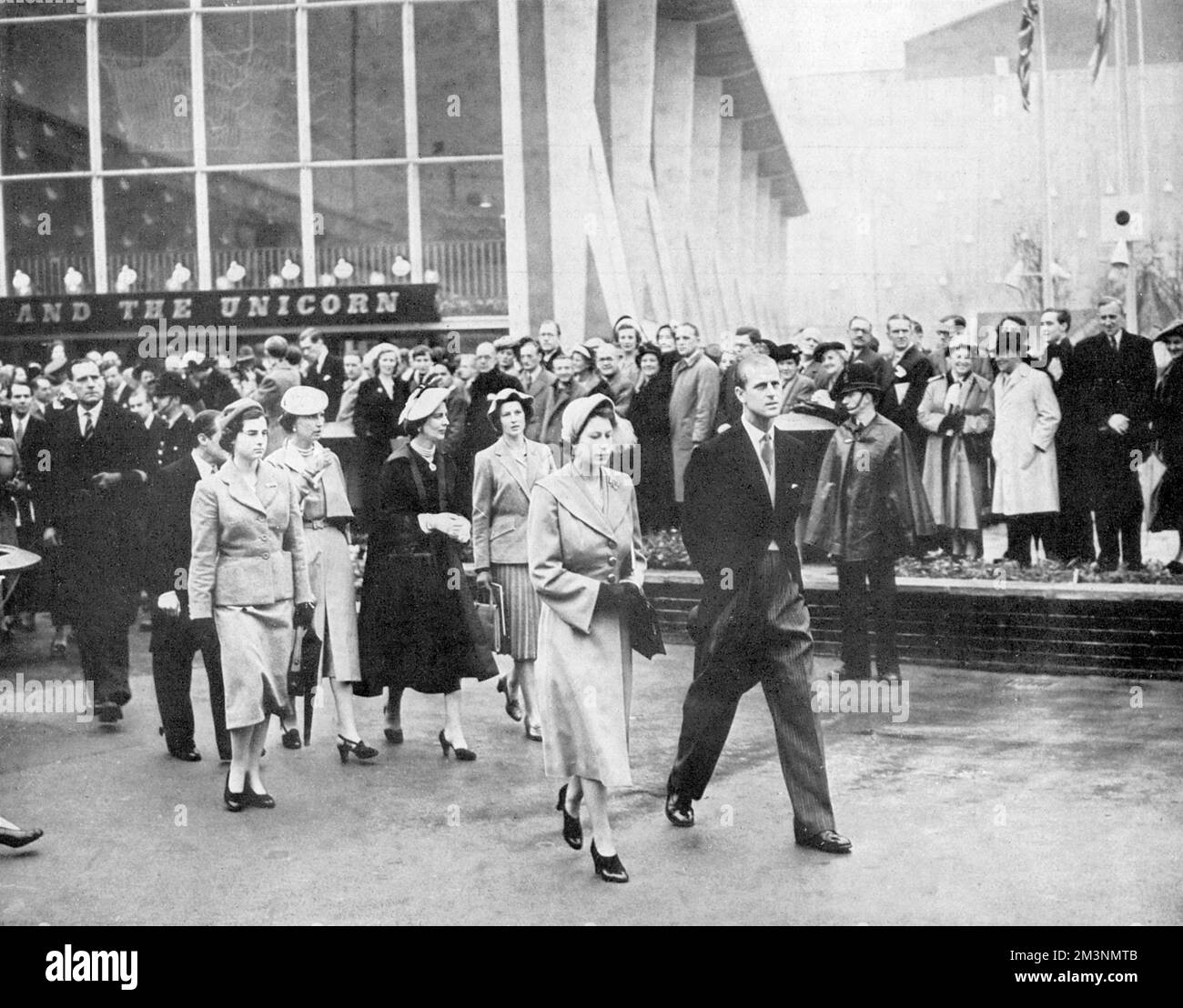 Princess Elizabeth (Queen Elizabeth II) and Prince Philip, Duke of Edinburgh pictured on their tour of the Festival of Britain site on the South Bank, London in May 1951.  Behind them follow Princess Marina, Duchess of Kent, her sister Princess Olga, Olga's daughter Princess Elizabeth and Princess Alexandra of Kent.  Rising in the background is the Lion and the Unicorn Pavilion.     Date: 1951 Stock Photo