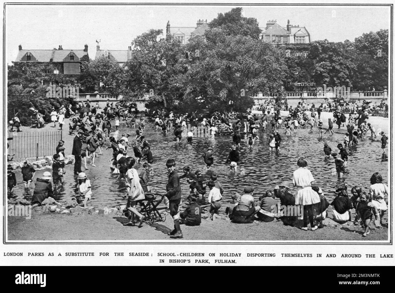 School children on holiday at the lake in Bishop's Park in Fulham, London.  1923 Stock Photo