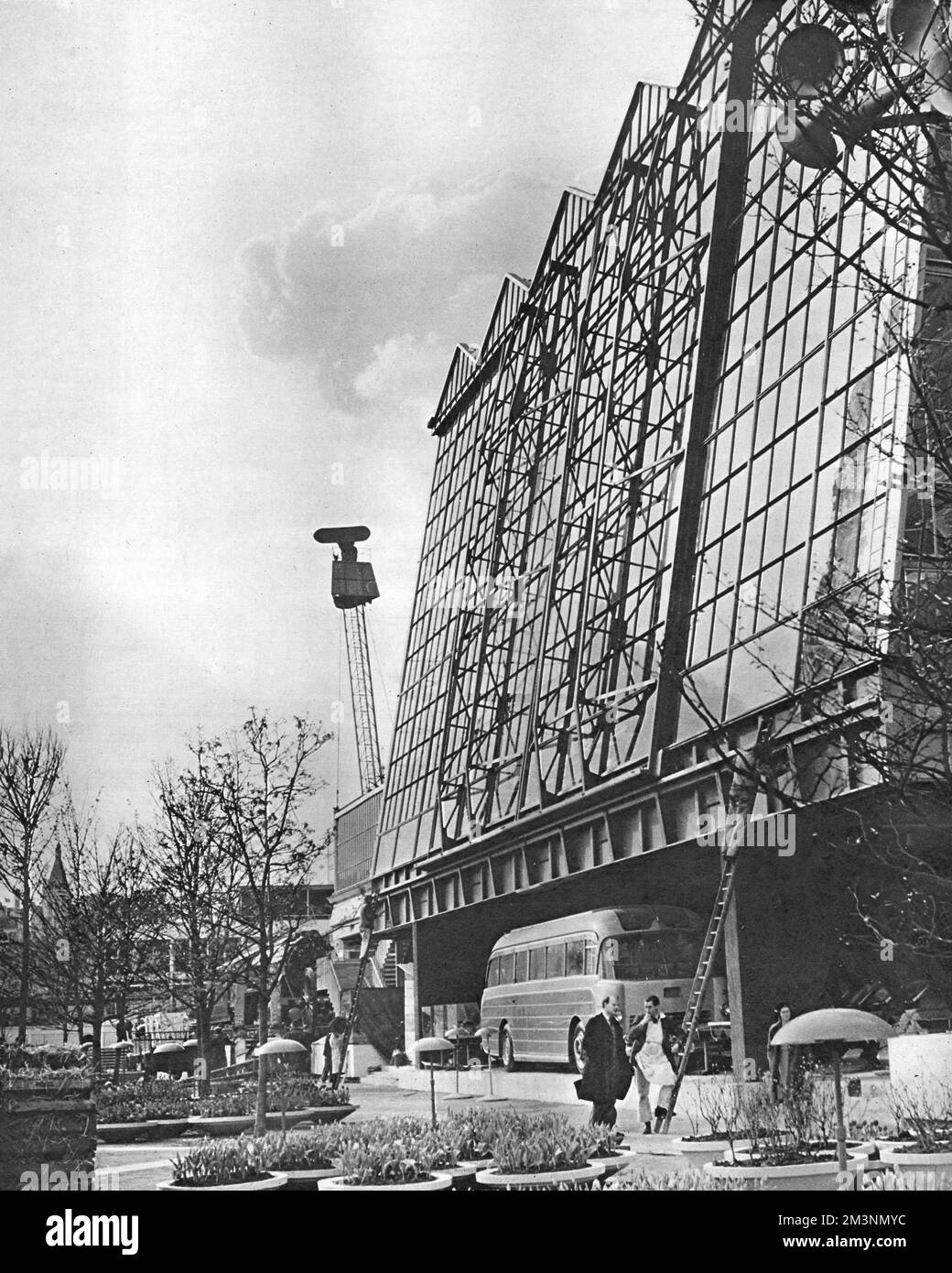 View of the gleaming glass facade of the steel-framed Transport Pavilion, part of the Festival of Britain site on the South Bank, London.  Exhibits covered the story of British travel by air, road, rail and sea.       Date: early 1951 Stock Photo