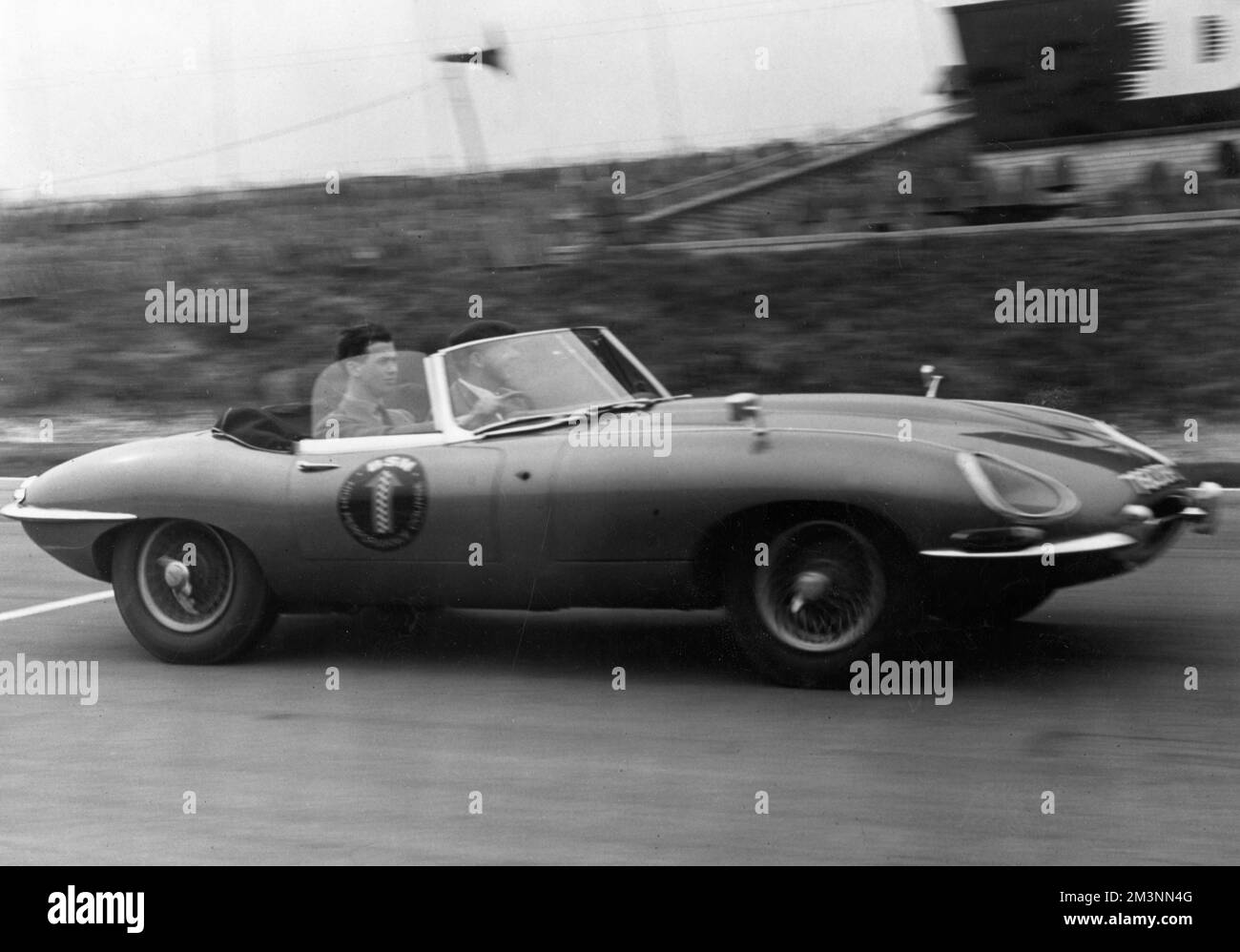Nineteen year old Prince Michael of Kent (born 1942) driving at 100mph in an E-type Jaguar at Brands Hatch race track in April 1962.  The Prince had recently become a member of the Institute of Advanced Motorists in the previous week, passing his test in a Mini.     Date: 1962 Stock Photo