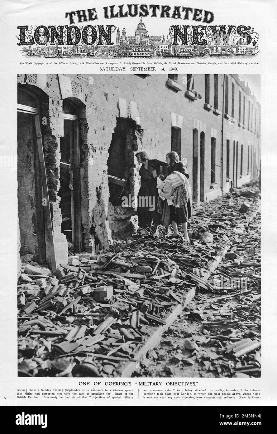 Residents from the bomb damaged street, peer through a huge whole in their house, viewing the utter destruction caused by Goering's men, and salvaging clothes and blankets from the ruins.     Date: September 1940 Stock Photo