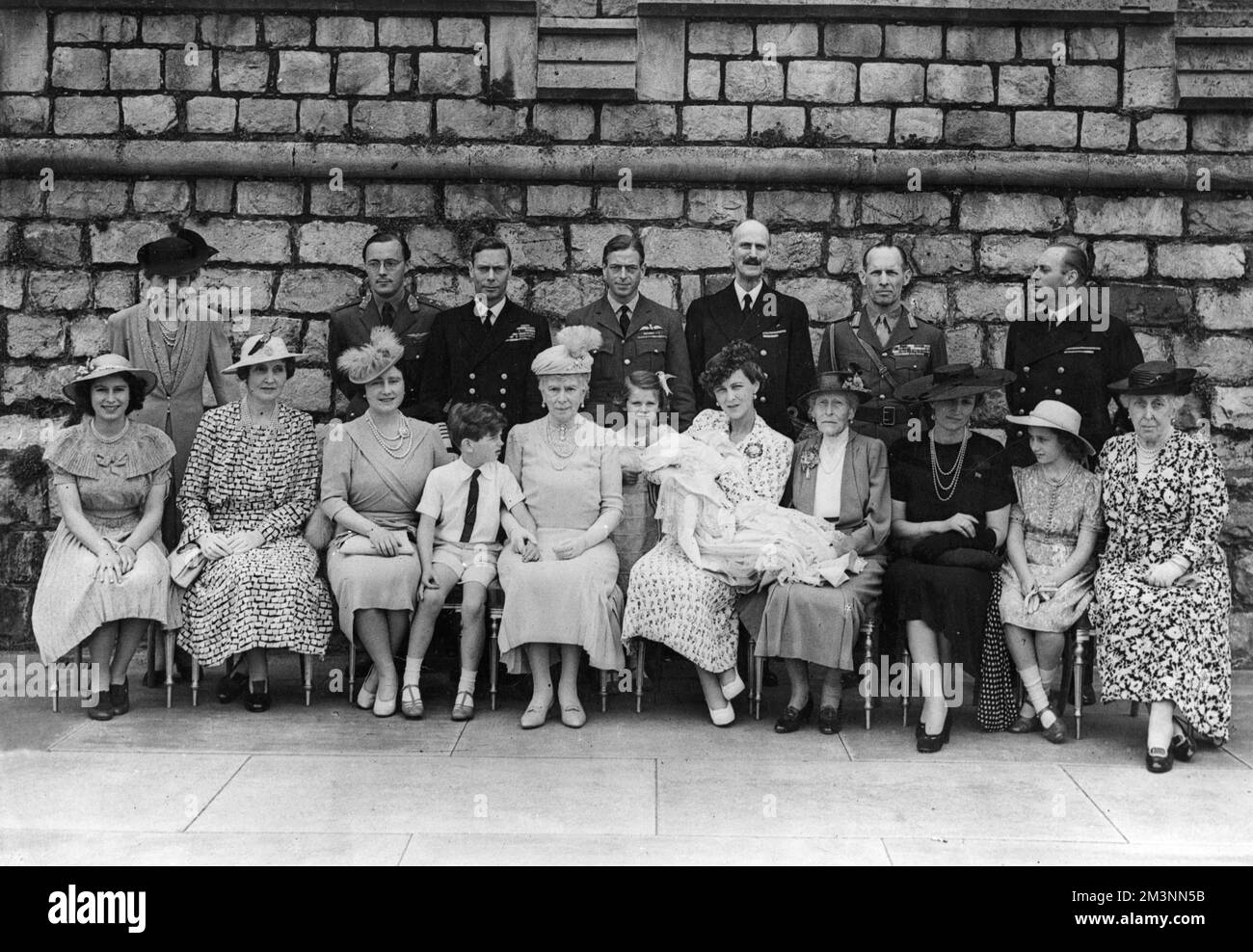 Christening of Prince Michael George Charles Franklin, third child of Prince George, Duke of Kent, and Princess Marina, Duchess of Kent.  He was born on 4 July 1942 and his father was killed in a flying accident while on duty when he was just seven weeks old.  Back row from left: Princess Marie Louise, Prince Bernhard of the Netherlands, King George VI, Duke of Kent, King Haakon of Norway, King George of the Hellenes, Crown Prince Olaf of Norway.  Seated from left, Princess Elizabeth (Queen Elizabeth II), Lady Patricia Ramsey (formerly Princess Patricia of Connaught), Queen Elizabeth, the Quee Stock Photo