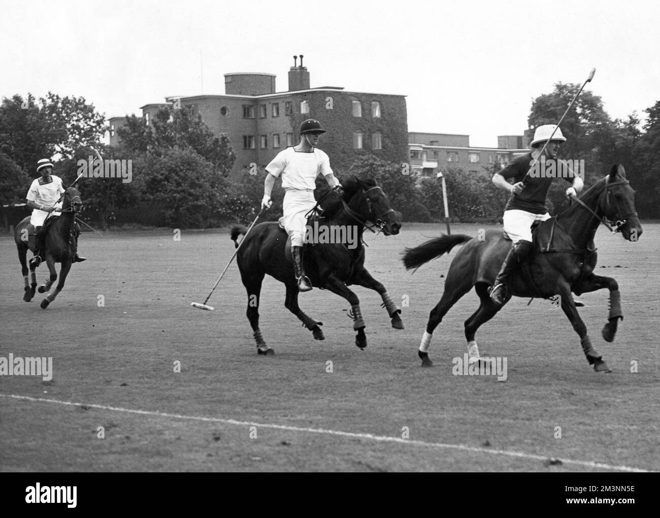 The quarter finals of the Polo County cup at Roehampton in July 1954 with Prince Philip, Duke of Edinburgh on the left, playing for the Mariners, following E. Lalor of the Henley team.     Date: 1954 Stock Photo