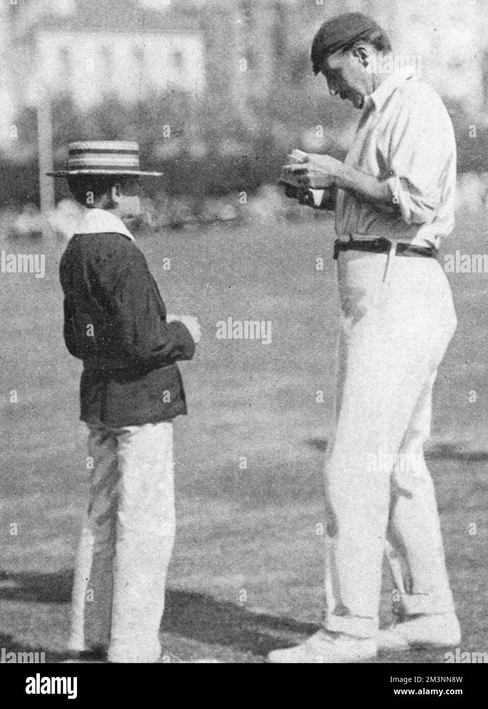 Lord Hawke, captain of the Yorkshire cricket team, signs an autograph for a young admirer during the match between county champions Yorkshire and an England XI which was played at Hastings between the 5th and 7th September, 1901      Date: September 1901 Stock Photo