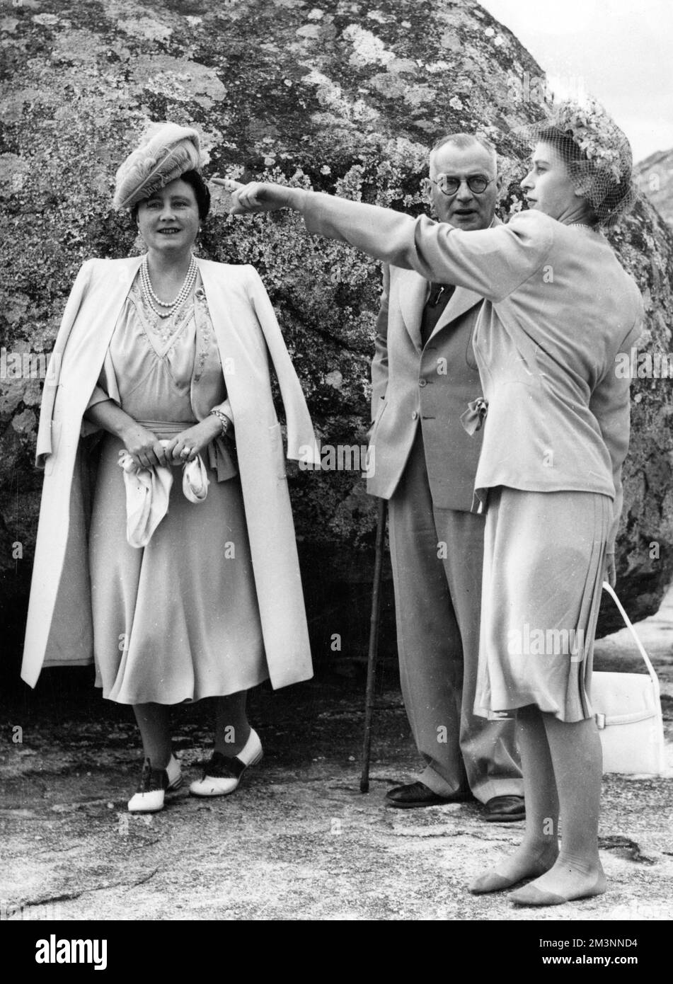 Princess Elizabeth stands shoeless with her mother the Queen after climbing the Matopos Hill, Bulawayo. The Queen had damaged her shoes during the climb, and the Princess lent her mother her own shoes, being worn by the Queen in the picture.     Date: 1947 Stock Photo