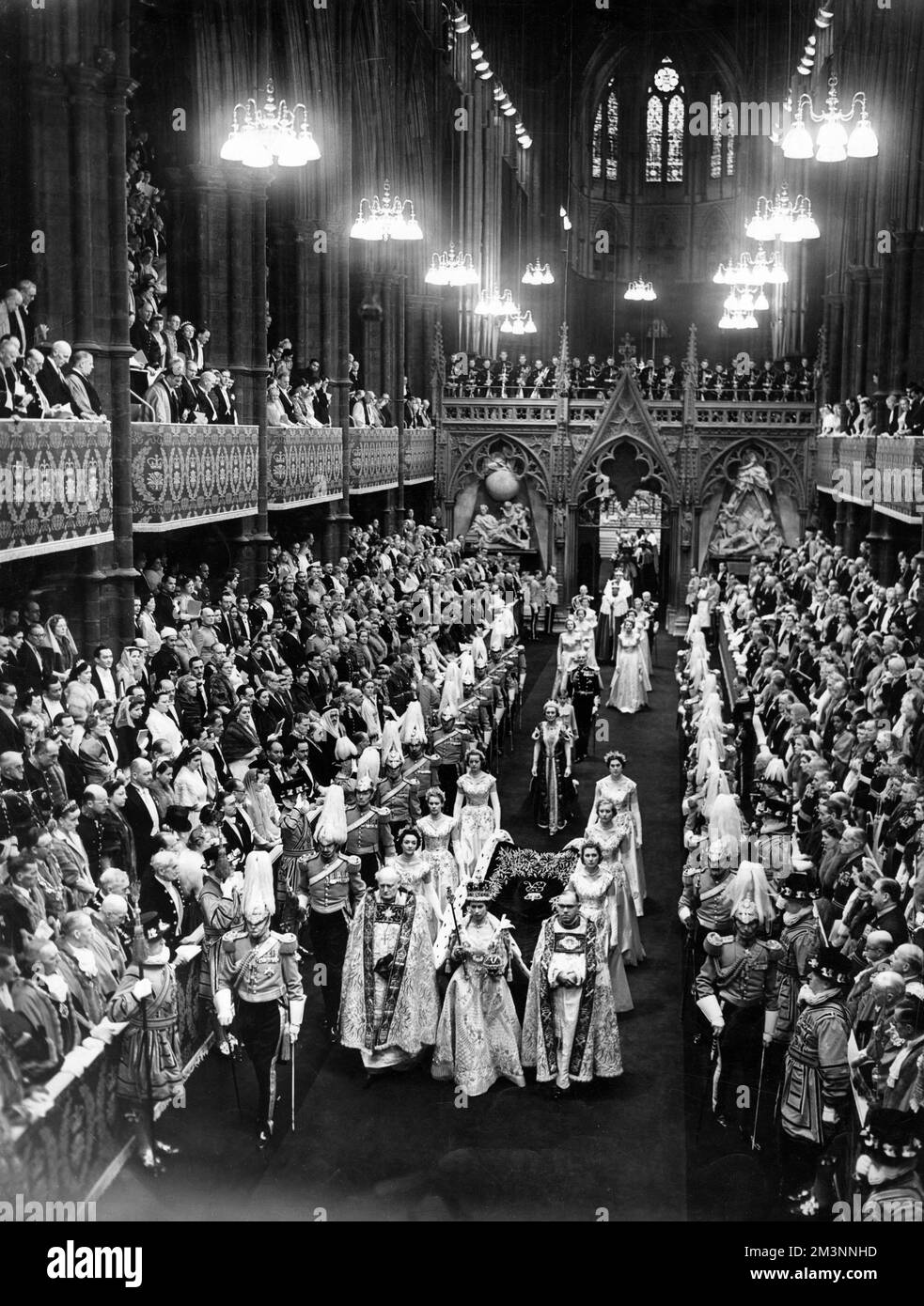 General view of the State Procession down the Nave led by H. M. The Queen, flanked by her Maids of Honour after the Coronation ceremony in Westminster Abbey on June 2nd 1953.     Date: 1953 Stock Photo