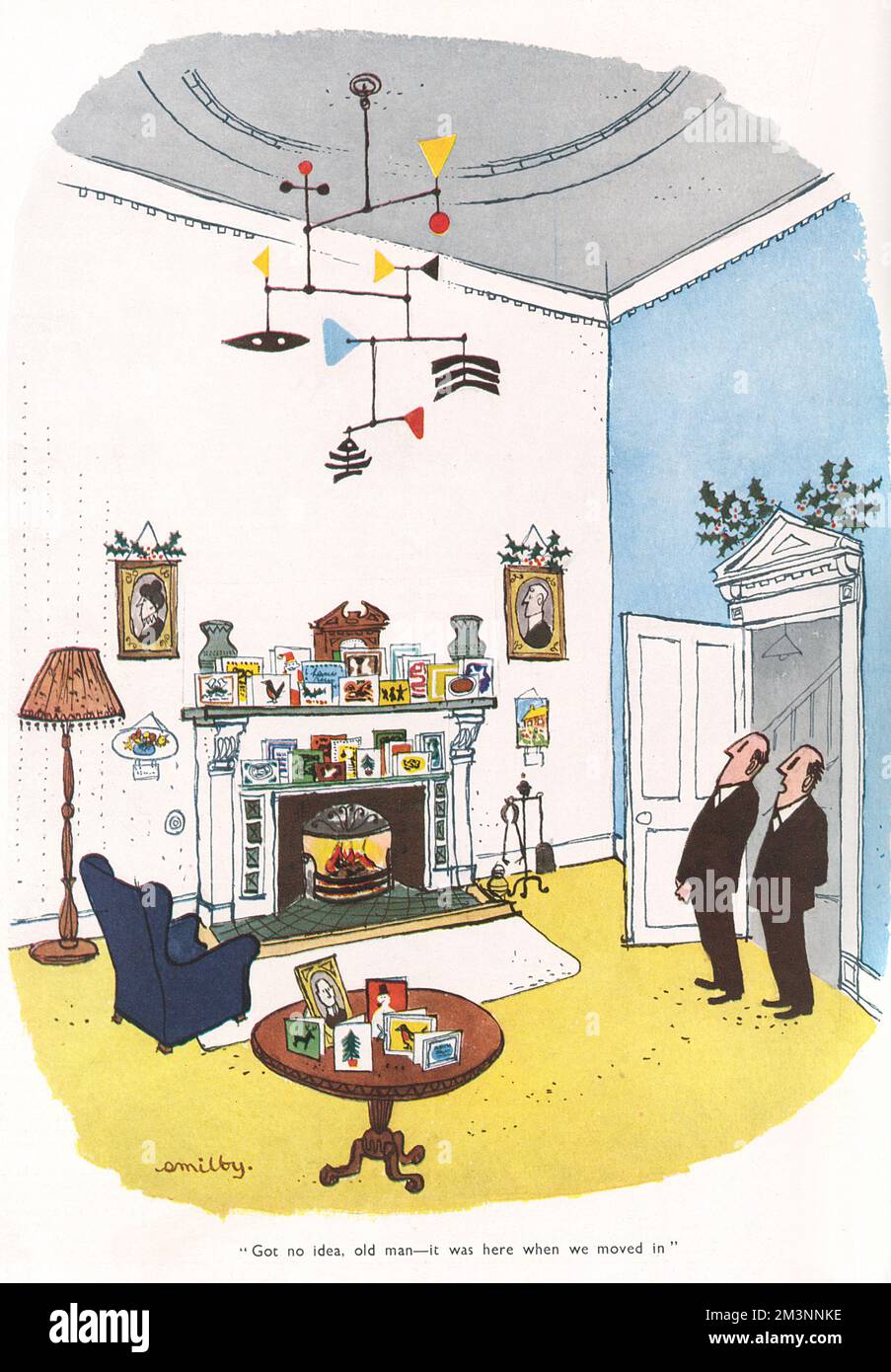 Two rather conservative gentlemen survey with curiosity a hanging Atomic style mobile in an otherwise traditional sitting room while one comments to the other, 'Got no idea, old man - it was here when we moved in.'     Date: 1953 Stock Photo