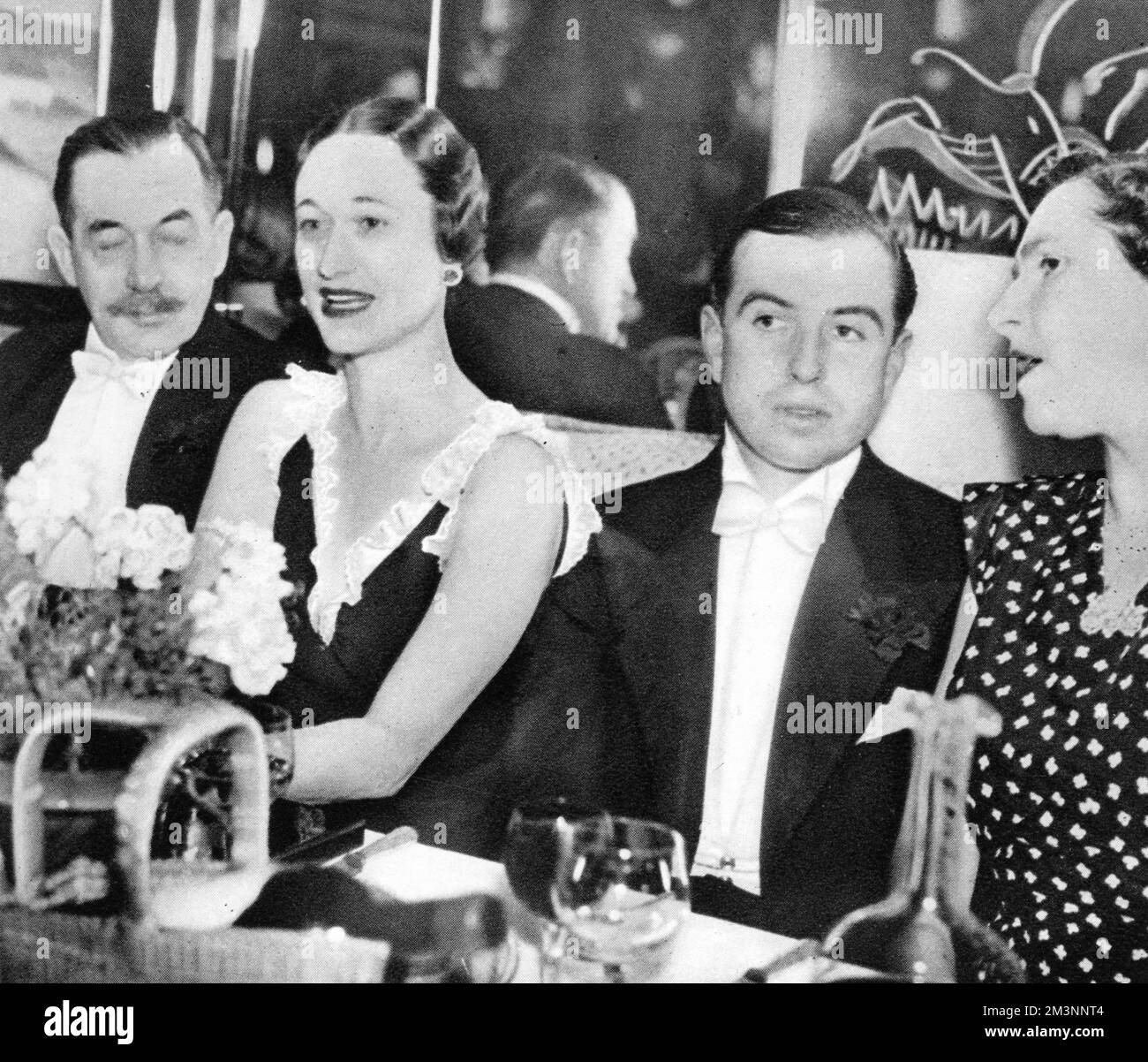 Wallis Simpson (Mrs Ernest Simpson), later Duchess of Windsor, pictured with (from left), Lieutenant Colonel M. F. Scanlon, the Assistant Military Attache at the American Embassy, Mr Rowley Byers and Mrs Scanlon, at the opening night of Quaglinos in London.     Date: 1936 Stock Photo