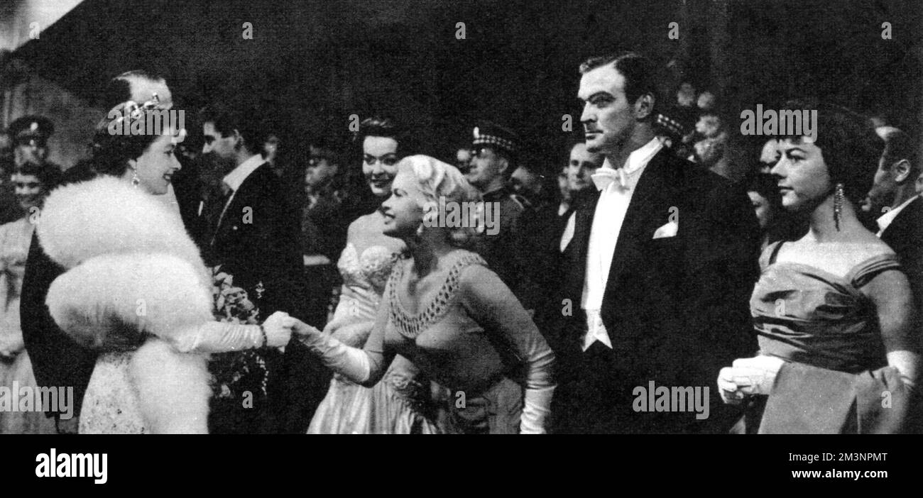 Actress Jayne Mansfield curtseys to Queen Elizabeth II, following the Royal Film Performance at Leicester Square, London. Between the Queen and Jayne Mansfield are Michael Craig and Anne Heywood. On the right, awaiting presentation, are Stanley Baker and Dorothy Tutin. The choice of film for this performance was Les Girls, a musical comedy.     Date: 1957 Stock Photo