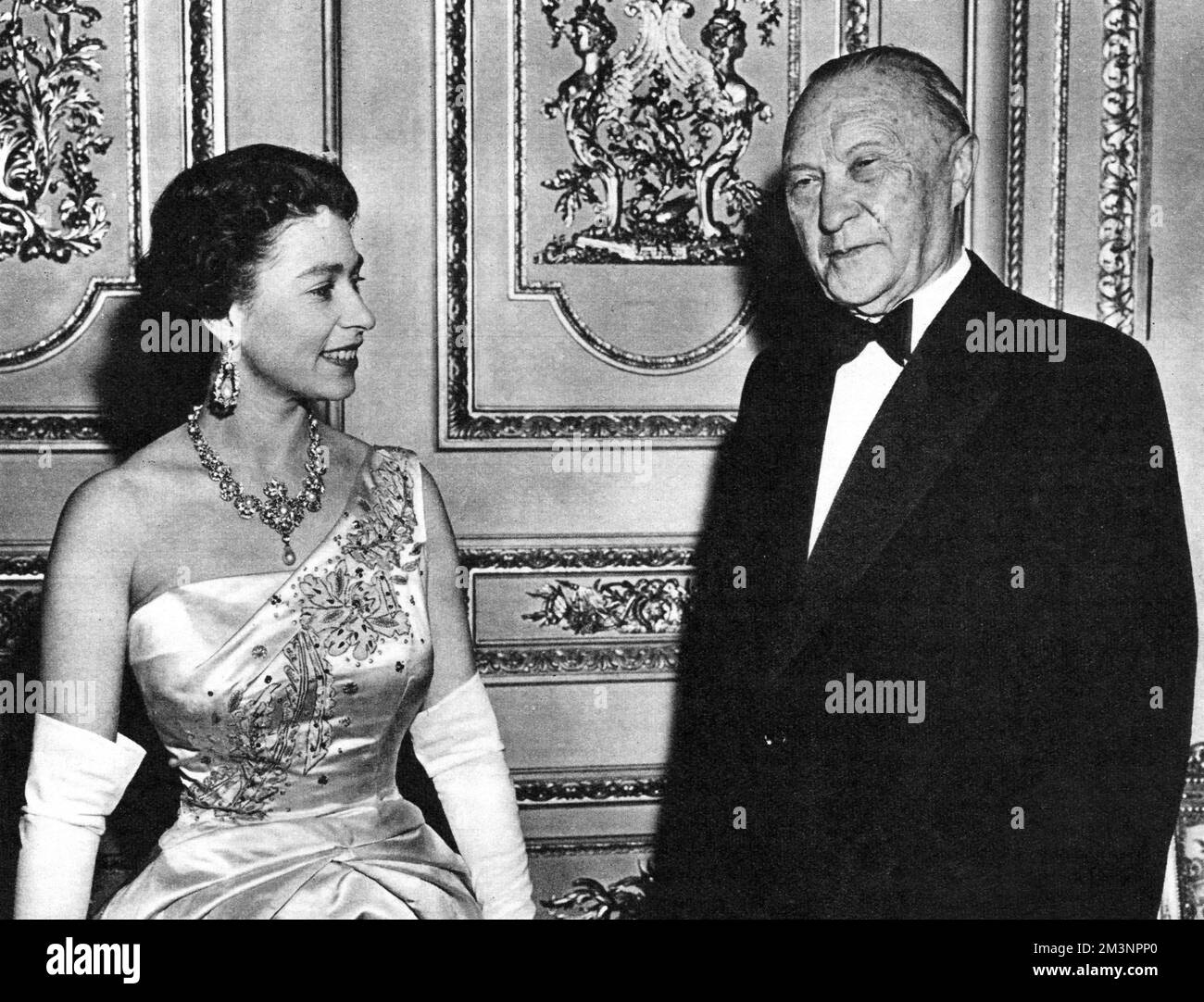 Queen Elizabeth II pictured with the Federal German Chancellor, Dr Konrad Adenauer at Windsor Castle during a dinner party given by Her Majesty and the Duke of Edinburgh, during a four day official visit of Adenauer to Britain.       Date: 1958 Stock Photo