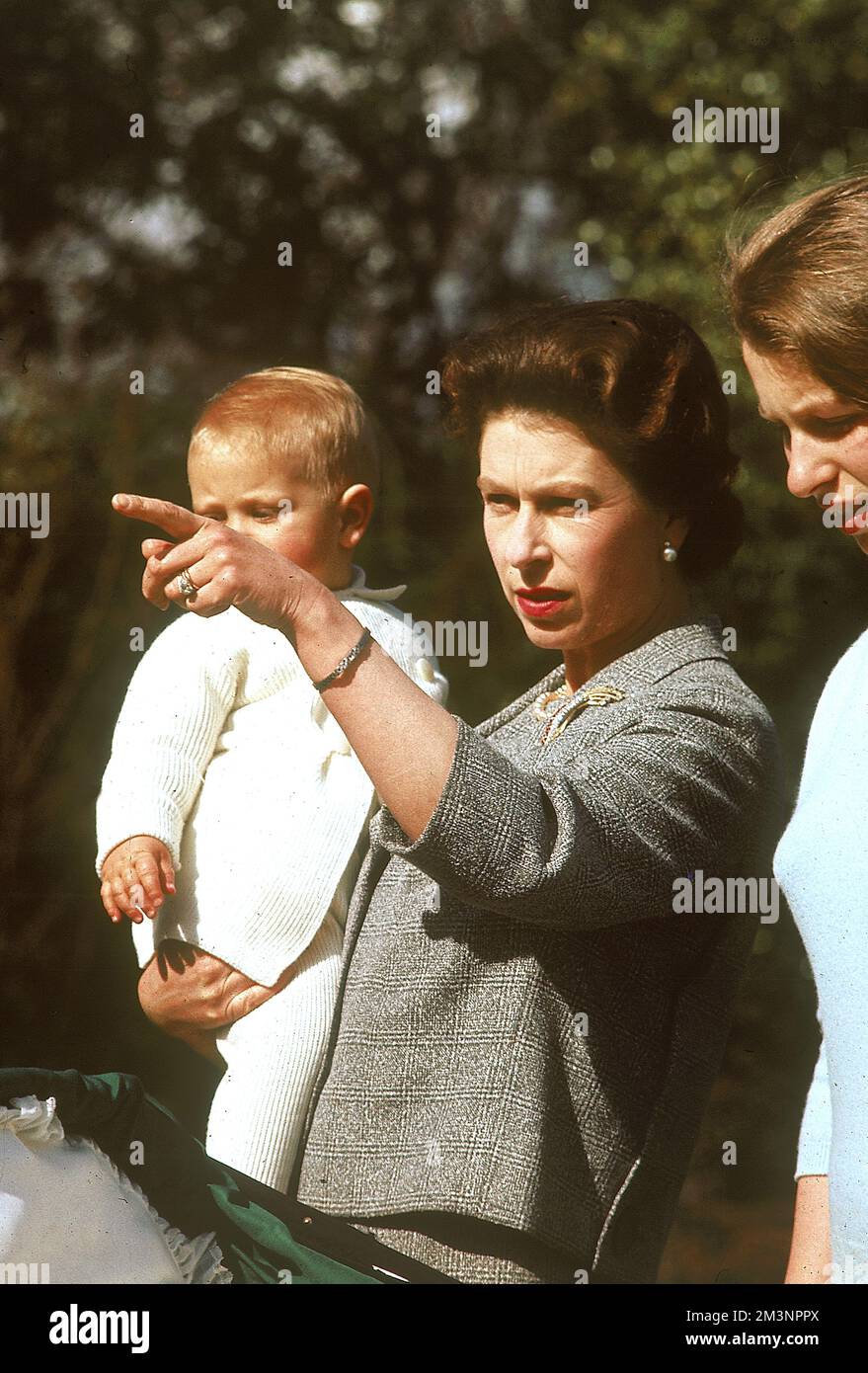 Queen Elizabeth II, holding a one year old Prince Edward (Earl of