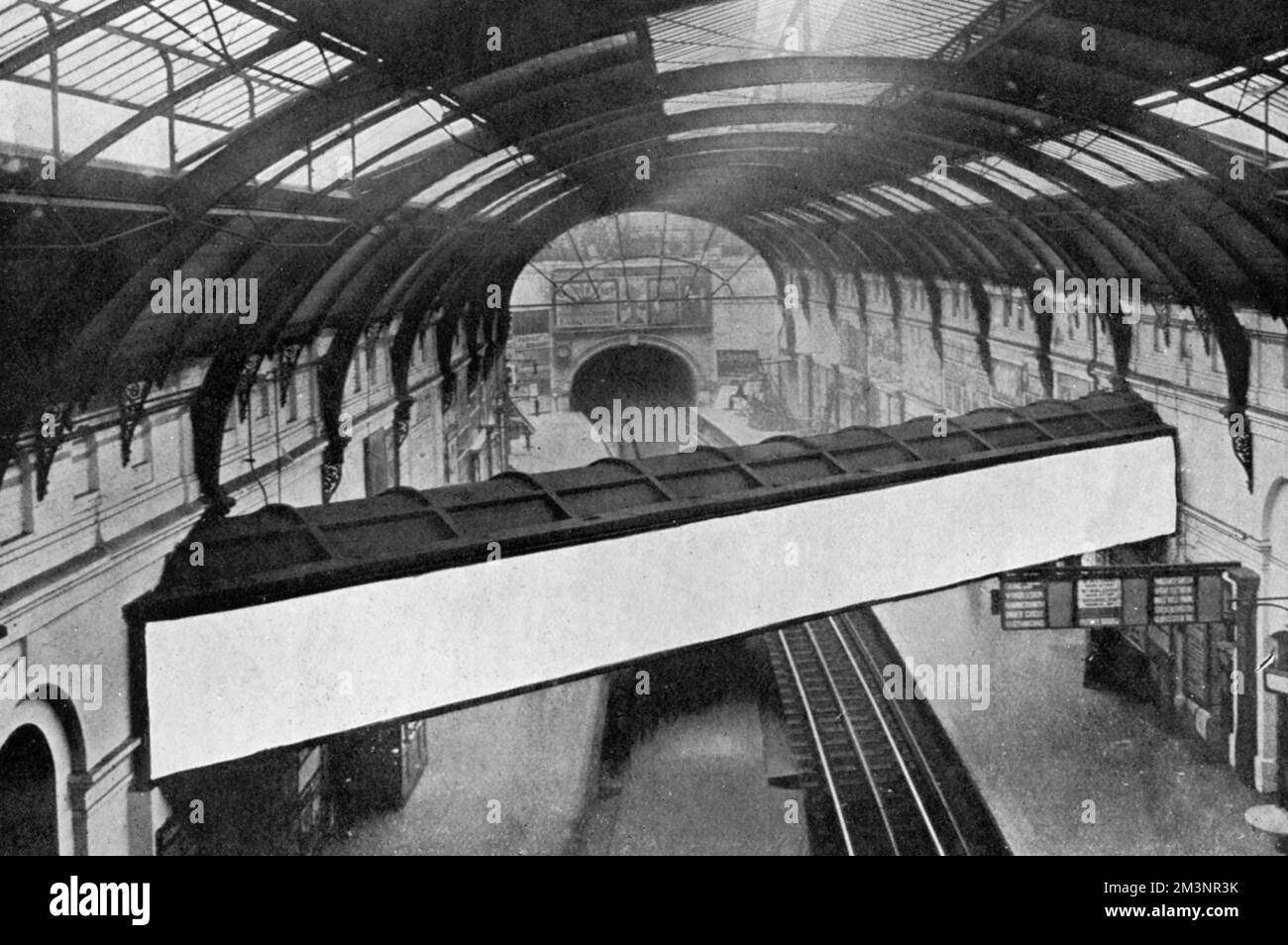 A conduit containing the overflow from the Serpentine running above the platforms at Sloane Square underground station.     Date: 1909 Stock Photo