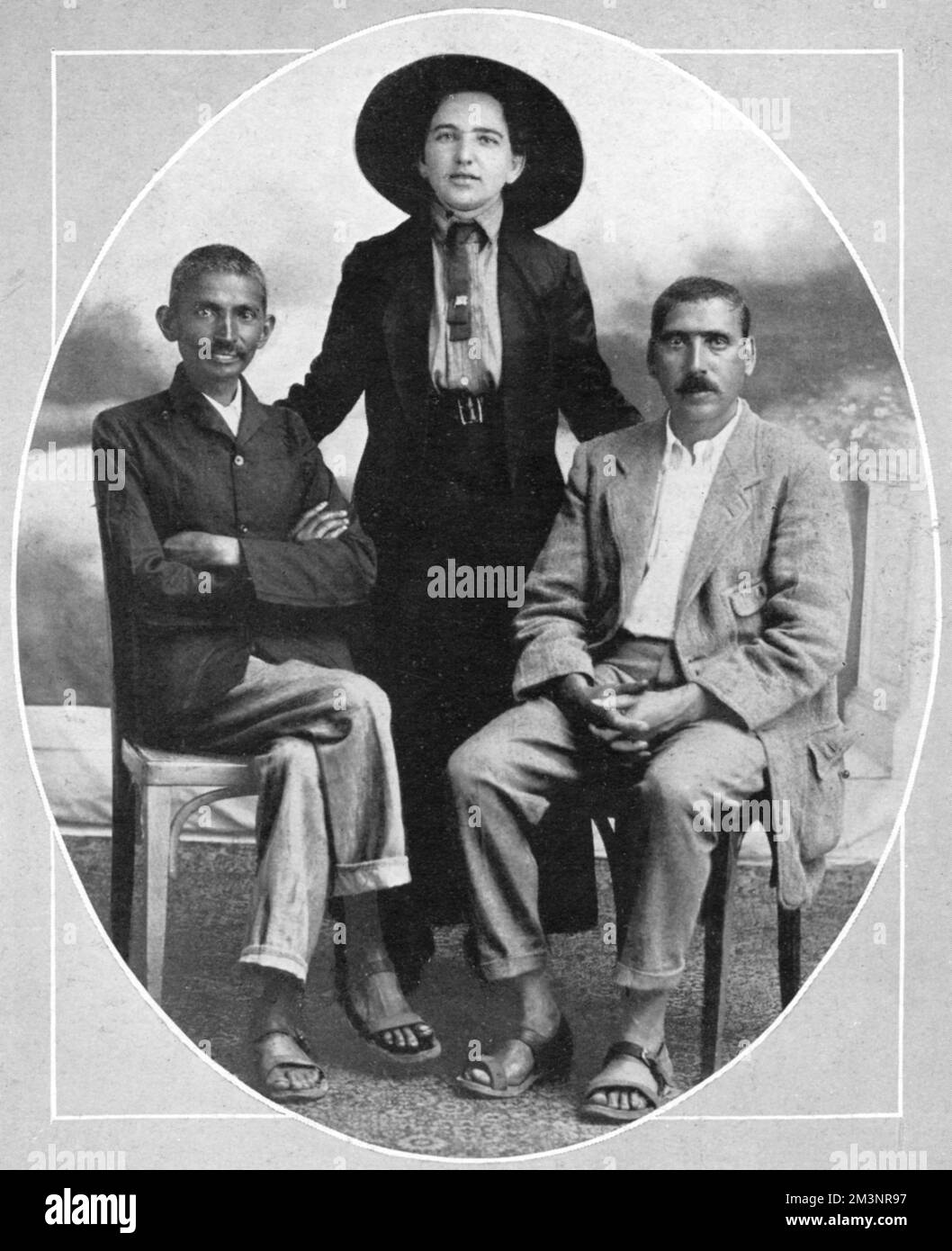 Mahatma Gandhi (1869 - 1948), Indian independence leader, during his time in South Africa when he was leader of the South African Indians and campaigned for them to be given equal rights to other British citizens.  Pictured with him are his secretary, Sonja Schlesin and his assistant, Hermann Kallenbach.     Date: 1913 Stock Photo