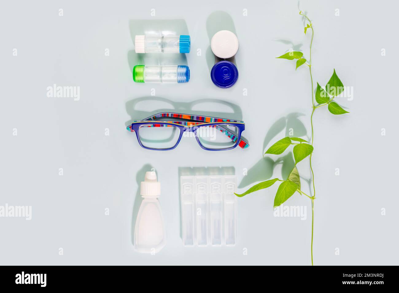 Oftalmology concept with kid eyeglasses, containers with contact lenses