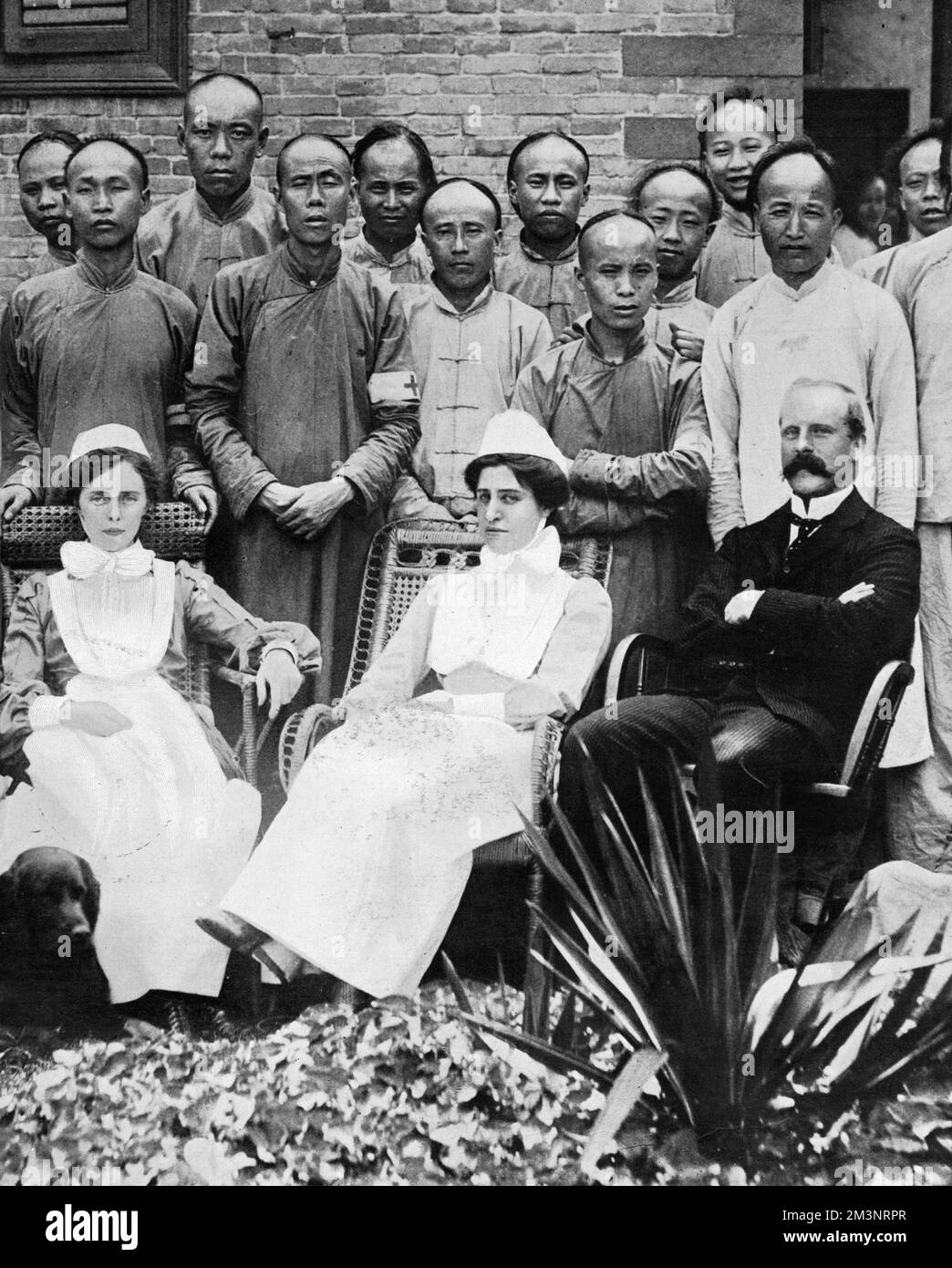 Dr. W. A. Tatchell pictured with two nurses, all from the Wesleyan Men's Hospital in Hankow, who rescued wounded and blinded inmates from the hospital under fire from insurgents during the Chinese Revolution of 1911. Dr. Tatchell was in China with Dr. Robert T. Booth and wrote a book about Dr. Booth entitled 'Booth of Hankow'        Date: 1911 Stock Photo